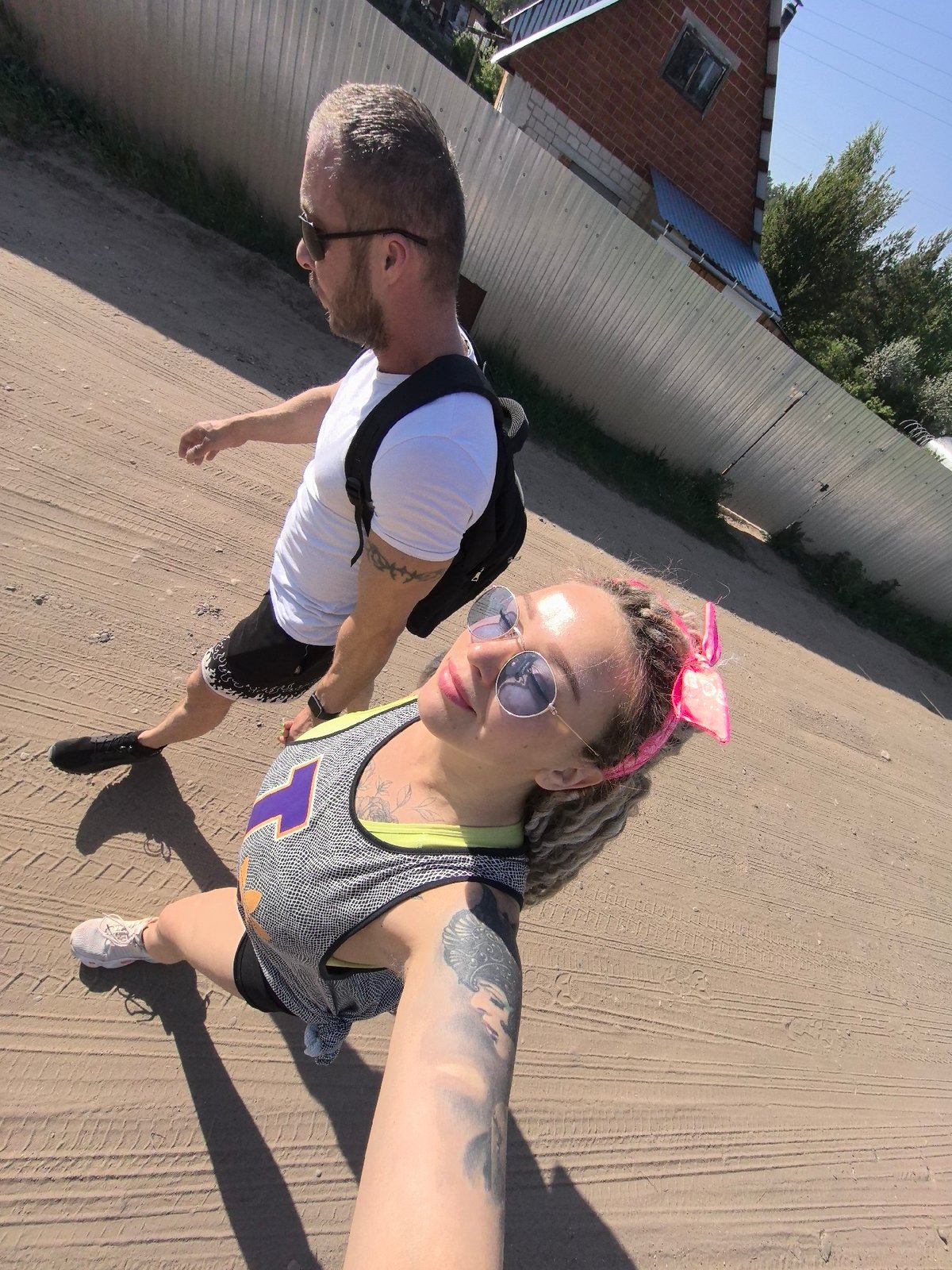 Couple photographed walking on dirt road in Noviy, Russia