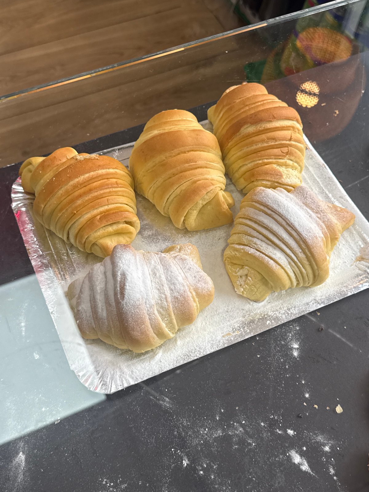 Morning food market displays fresh pastries and seafood