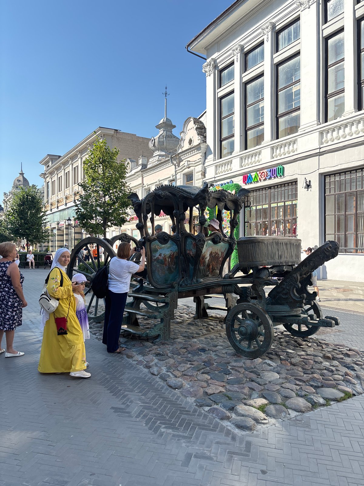 Bauman Street's sculptures, cafes, and street life on a July afternoon