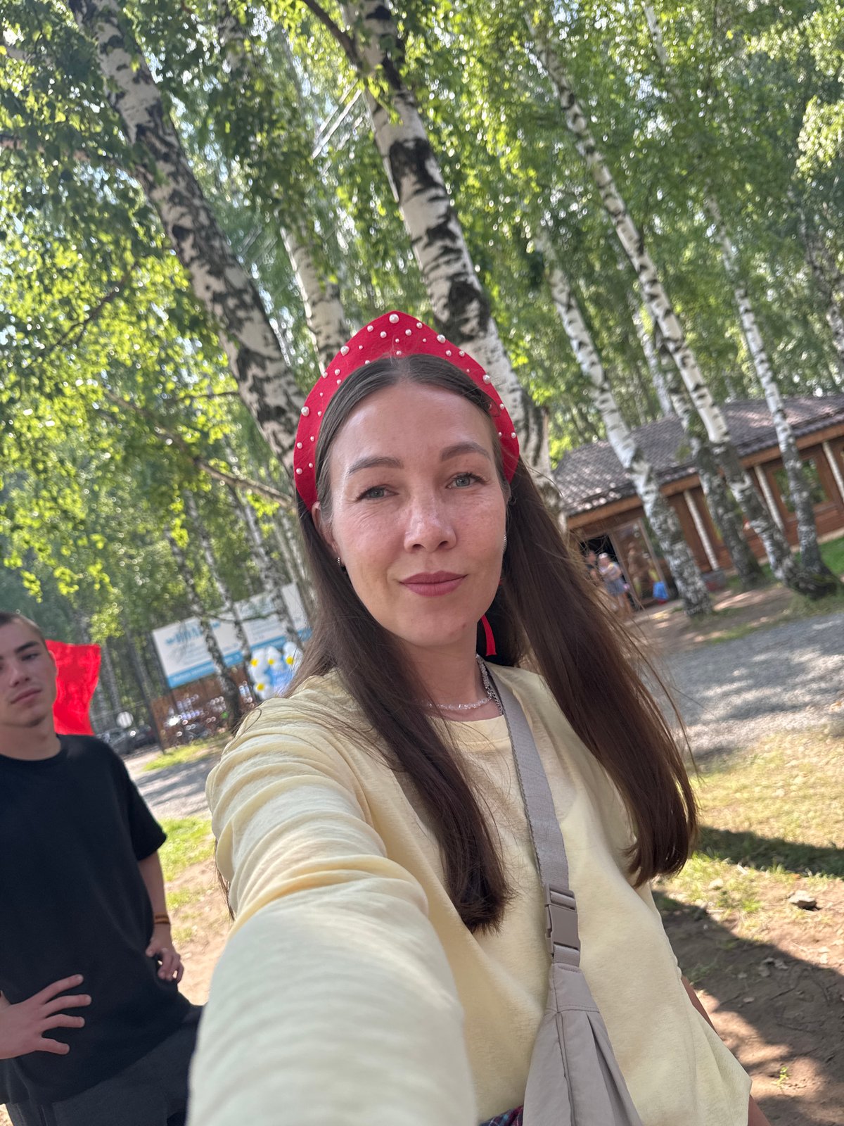 Outdoor selfie in Chaikovsky, yellow shirt and red headband.