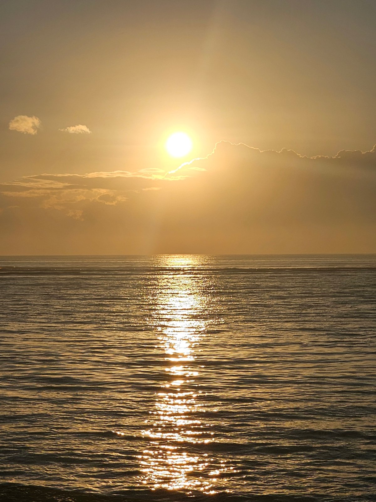 Sunset at Sanur Beach, Bali's coastline at golden hour