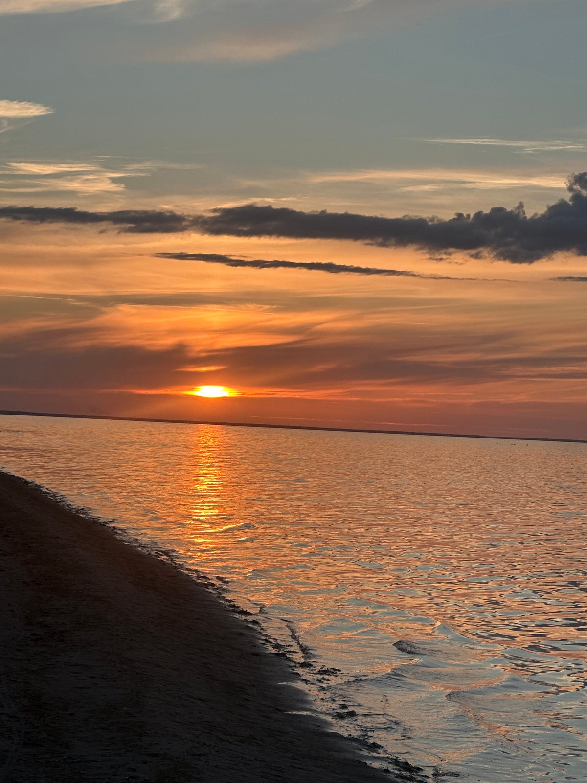 Baltic sunset glows orange over the Ragaciems coastline
