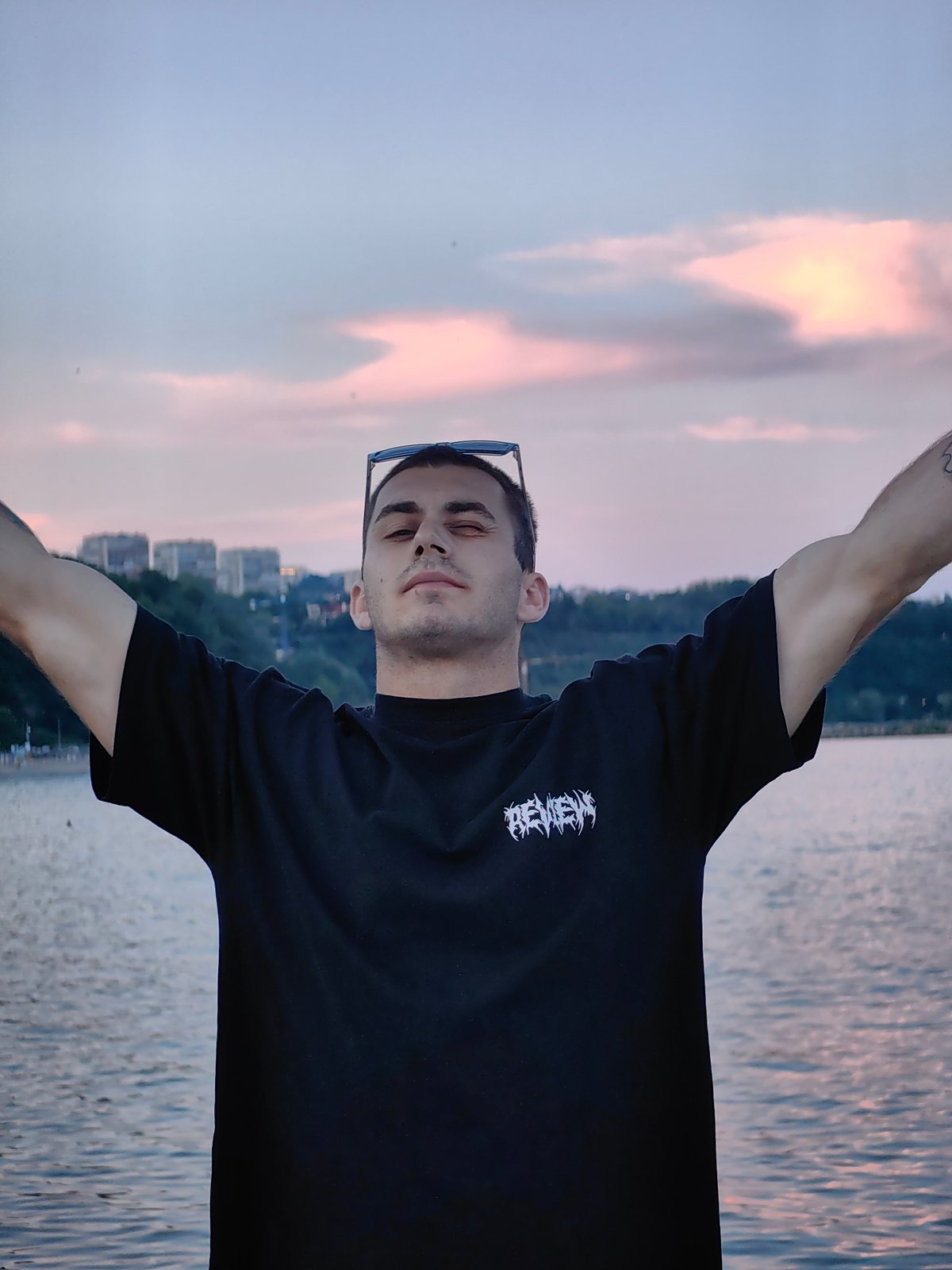 Young adults gather at waterfront pier for twilight photos