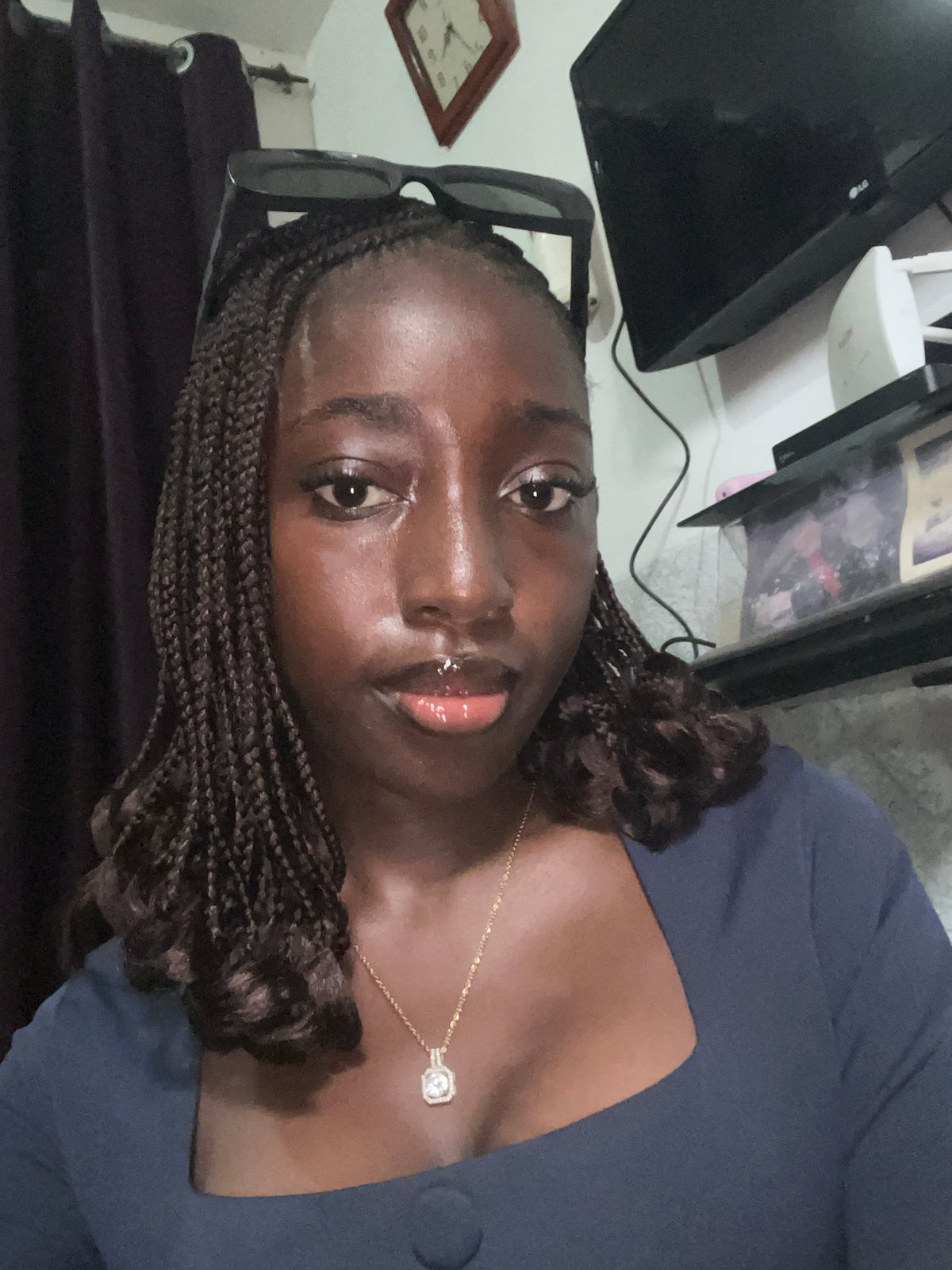 Woman photographed multiple times in navy dress, Abuja Nigeria
