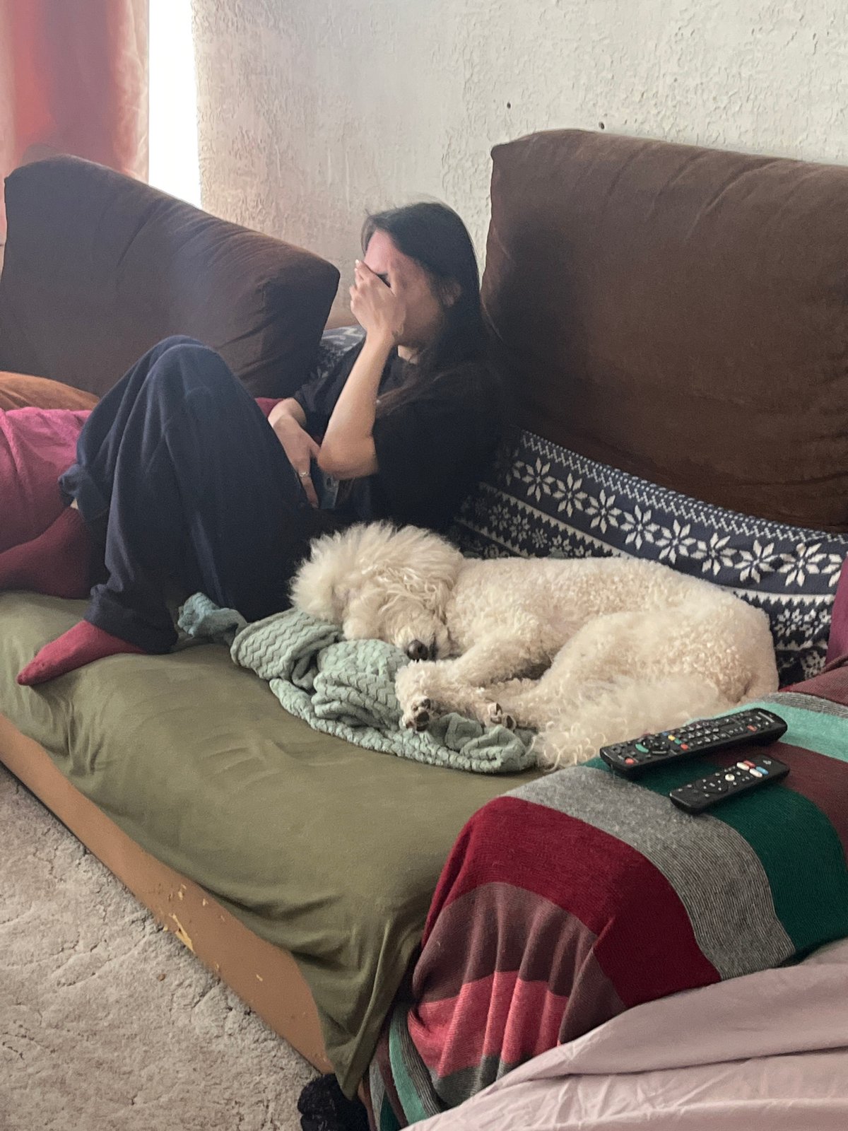 Woman shares quiet moments with white dog in Krasnoyarsk home