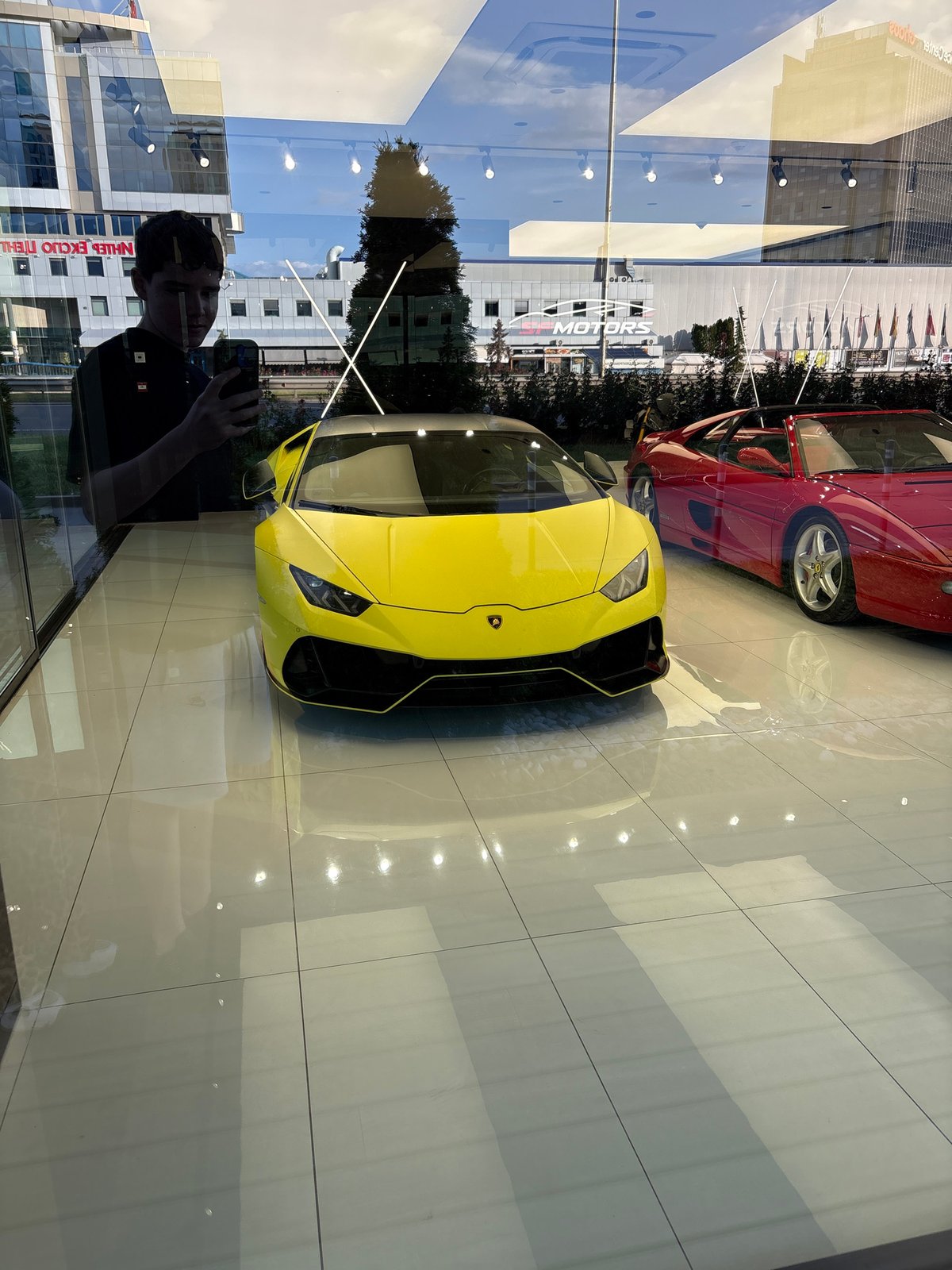 Sofia residents document luxury car, selfie, evening cityscape