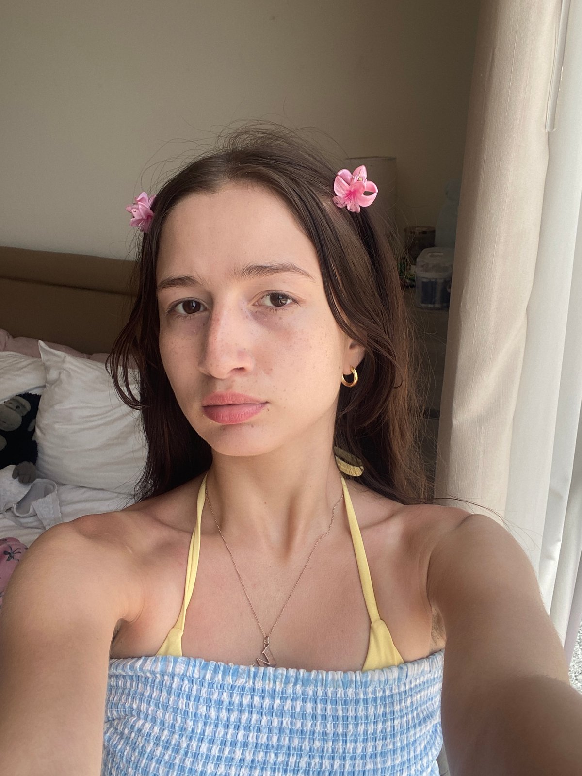 Woman models checkered dress in Dubai hotel room