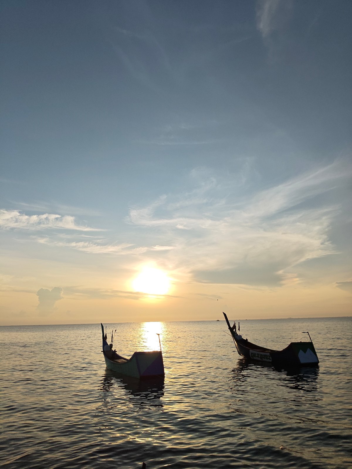 Fishing boats spotted in calm sunset waters off Lhokseumawe