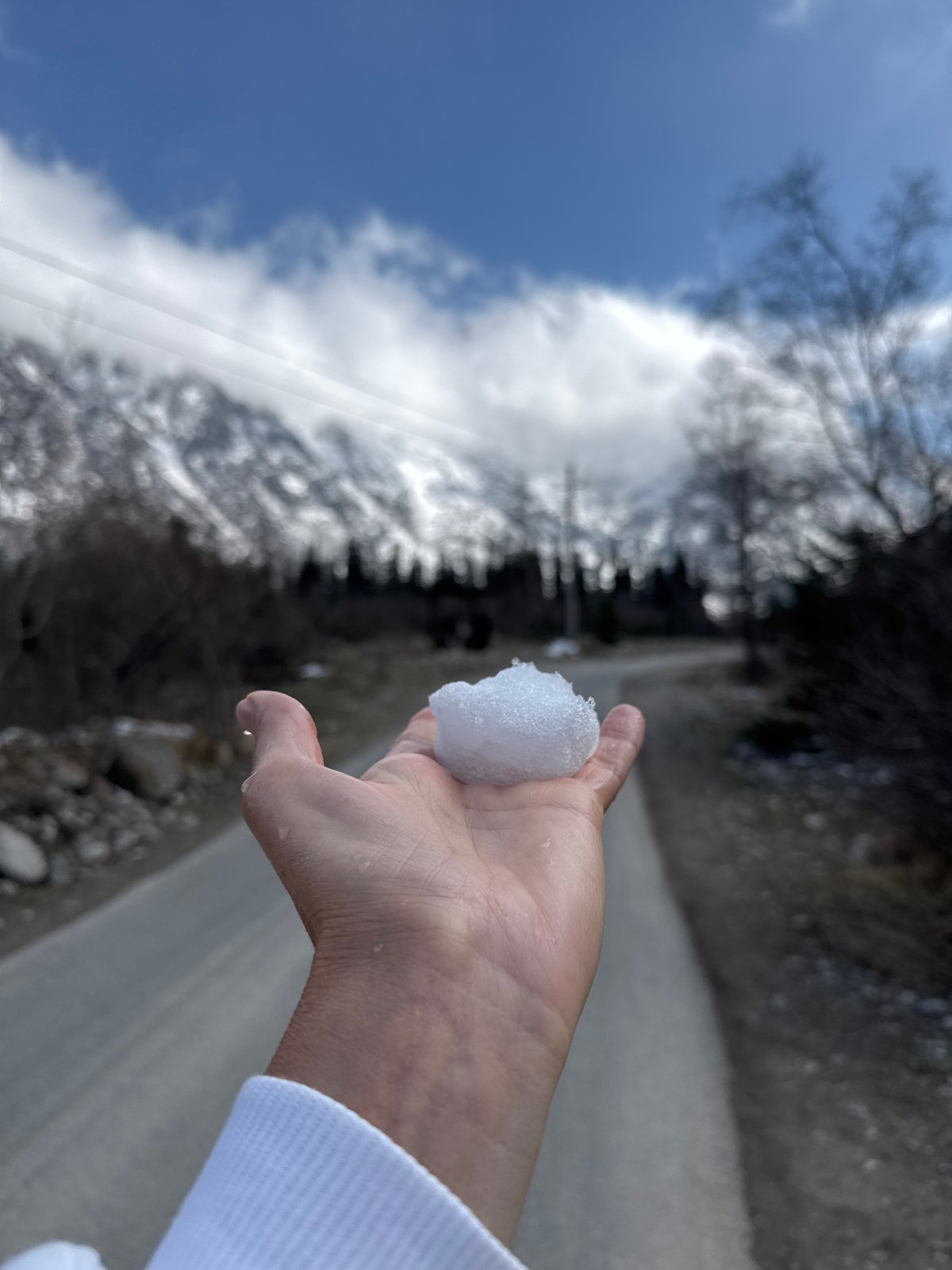 Tourists explore snowy Kyrgyzstan mountains, feed wildlife on spring morning