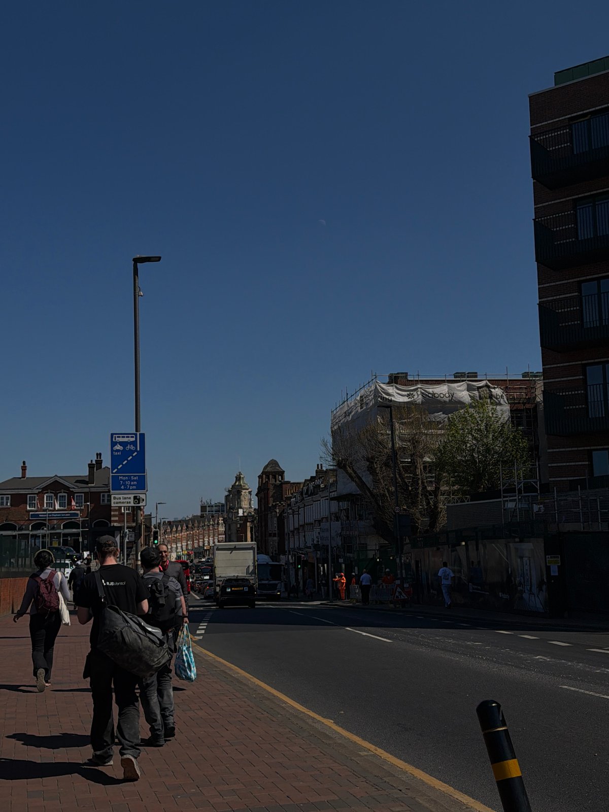 London street scene photographed sideways under clear blue sky