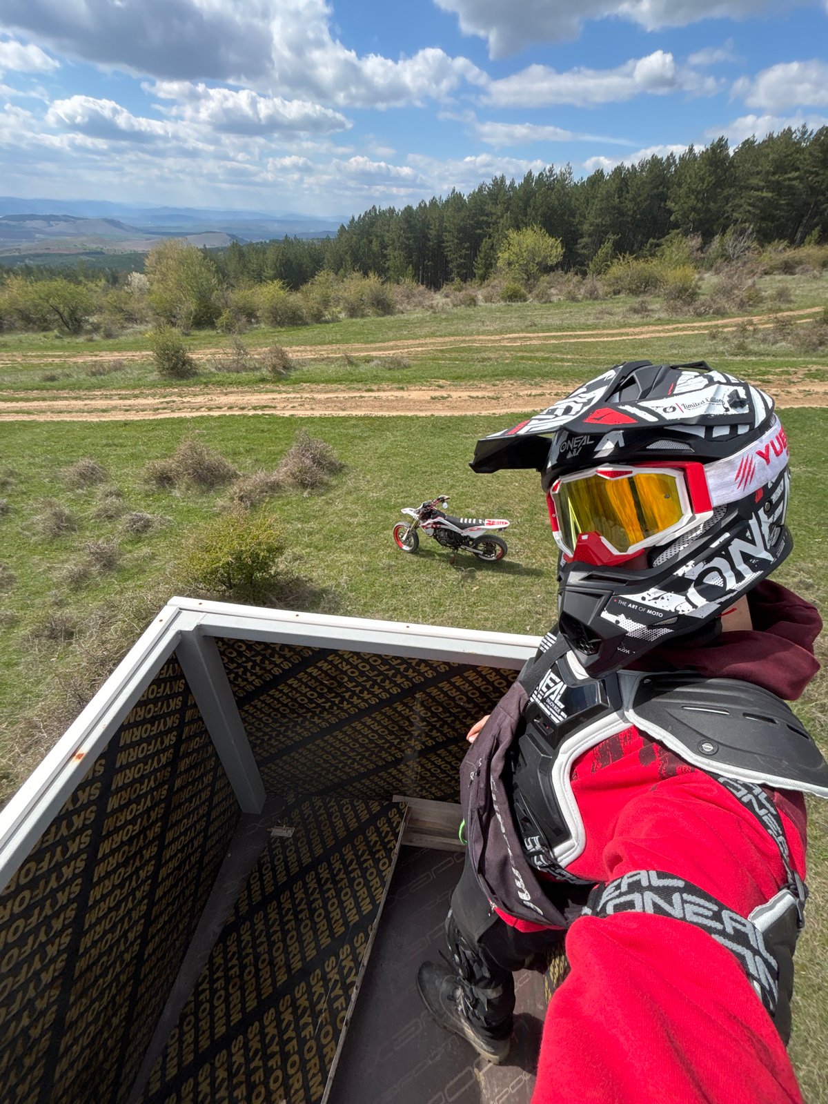 Motocross rider prepares for dirt bike session in Bulgarian countryside