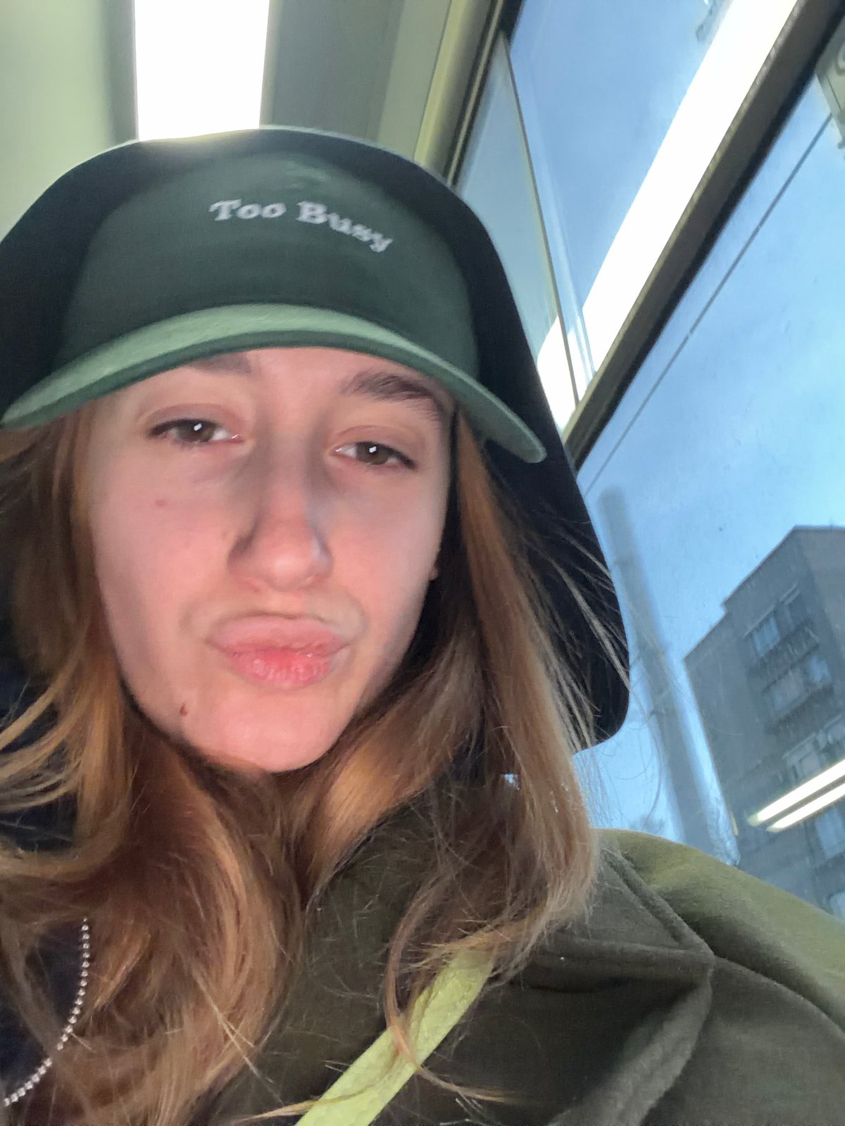 Woman takes selfies on busy Sofia street during afternoon