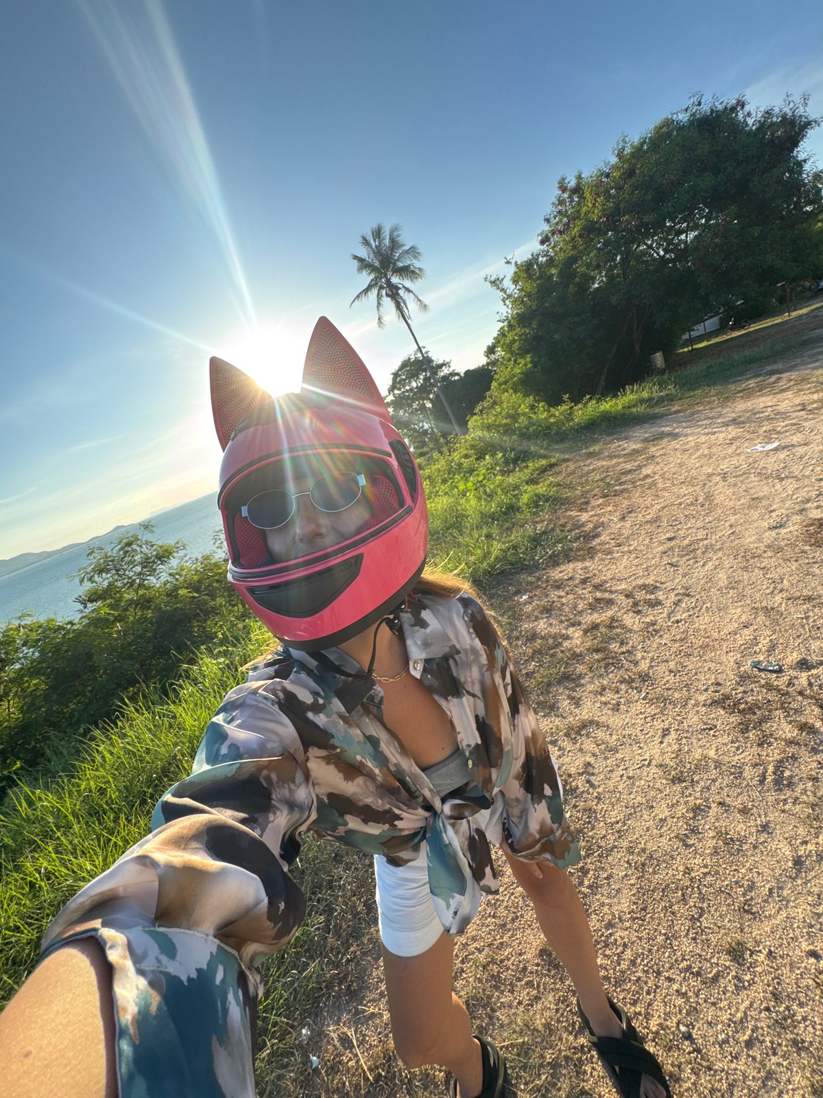 Scooter stop selfies at a tropical coastal overlook