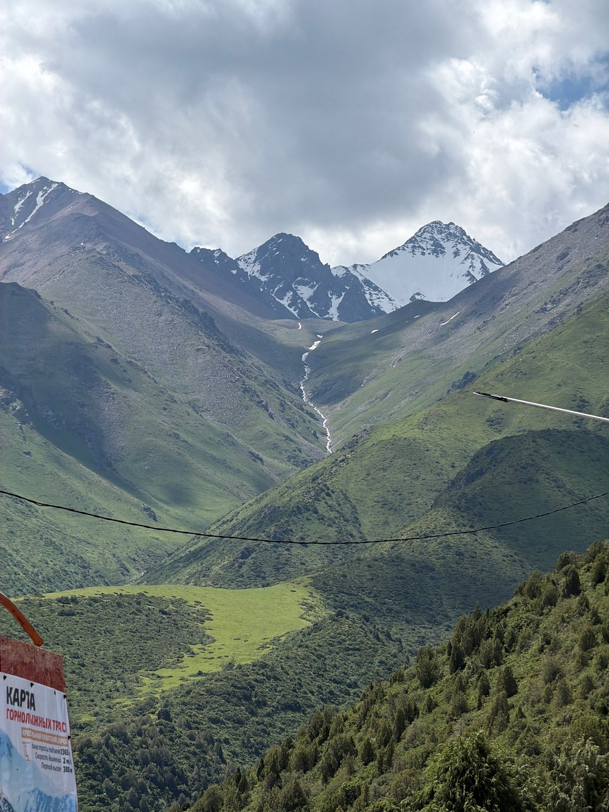 Kashka Suu ski resort in summer, lifts quiet and hills green
