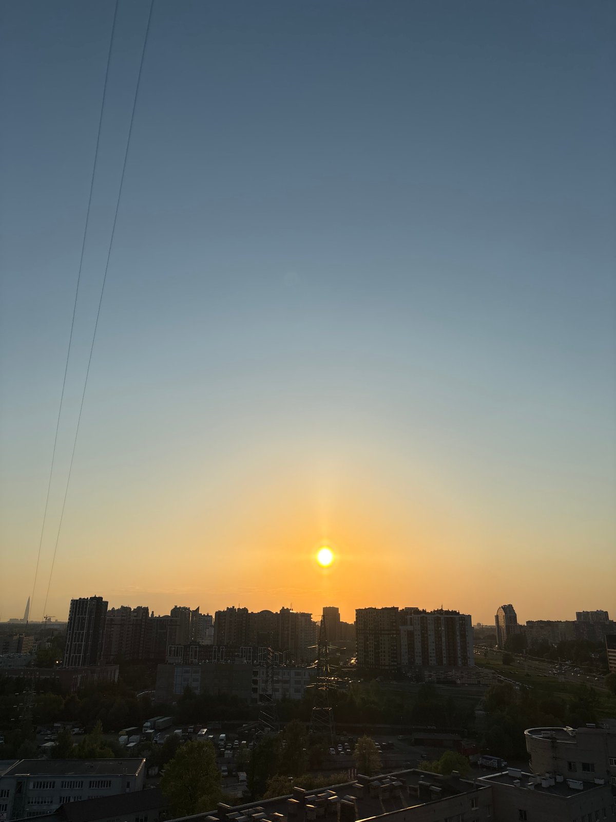 Witness captures sunset over dense urban cityscape