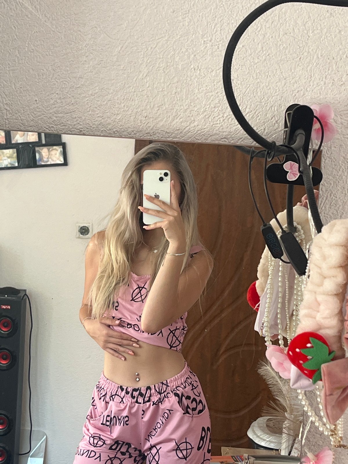 Mirror selfie in pink graphic pajamas, relaxed home setting.