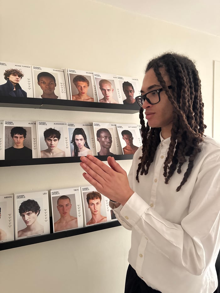 Person visits Paris modeling agency, examines comp cards