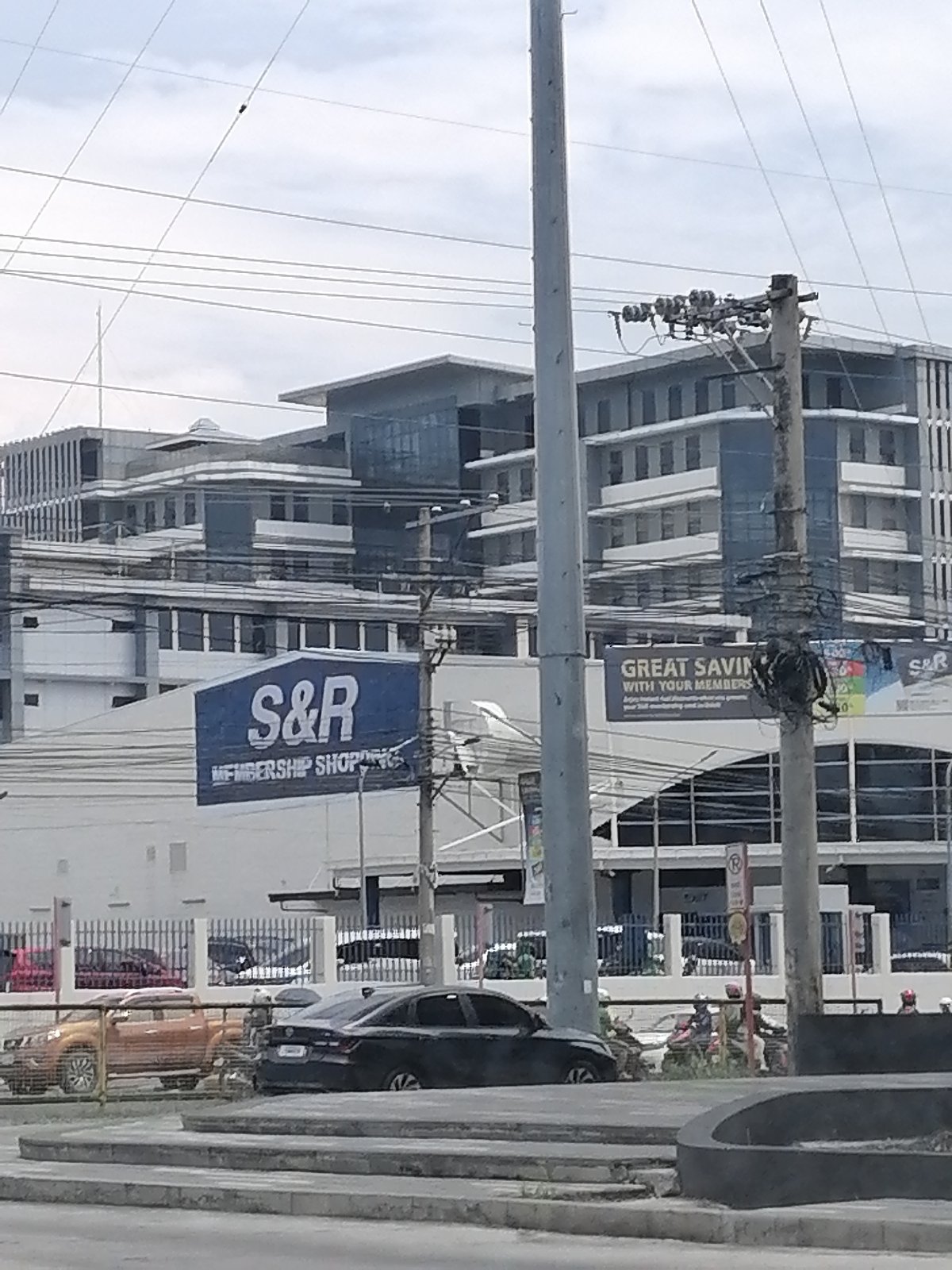 Overcast day captured on Davao City street with power lines
