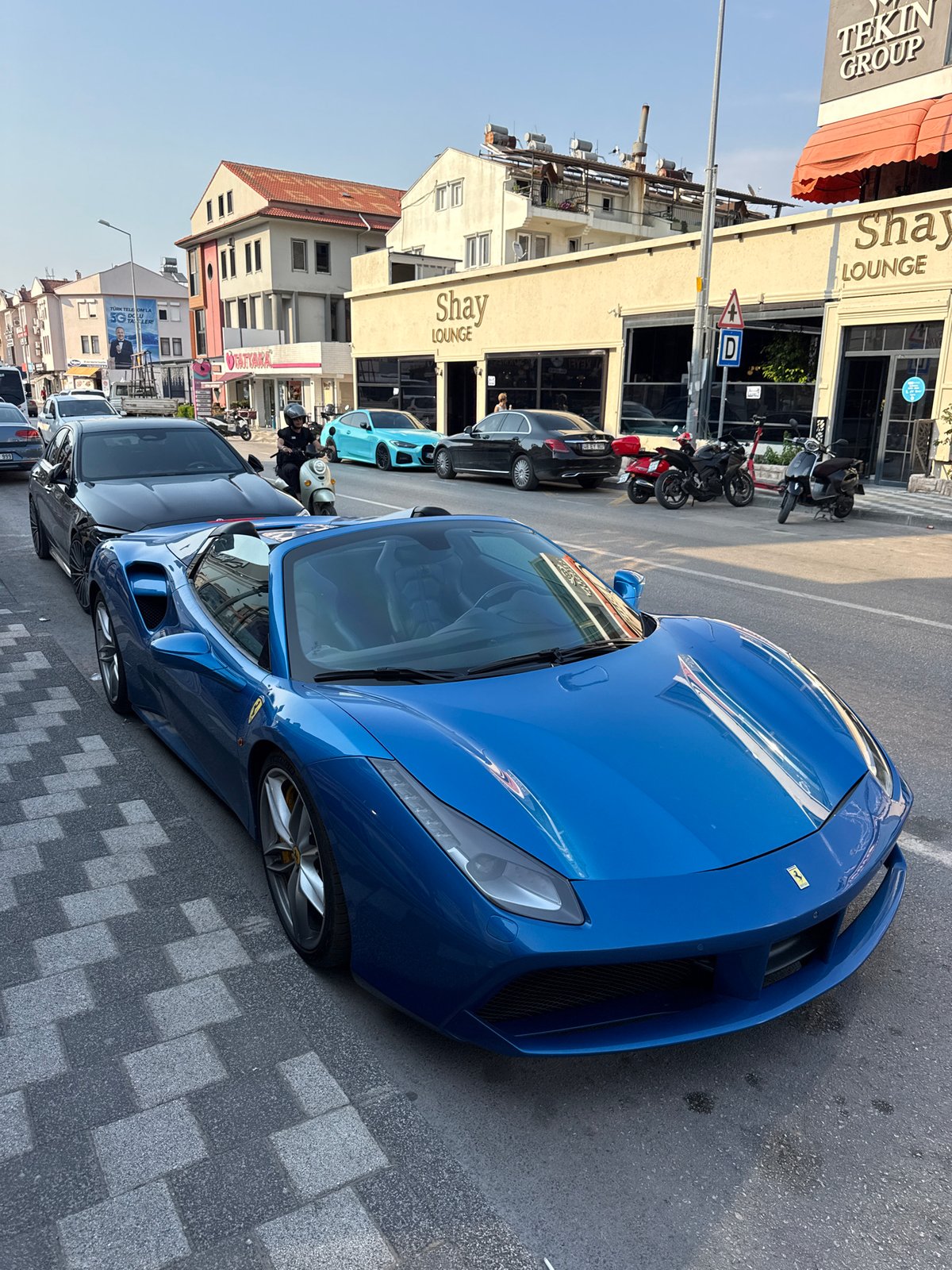 Blue Ferrari convertible parked on a Fethiye street