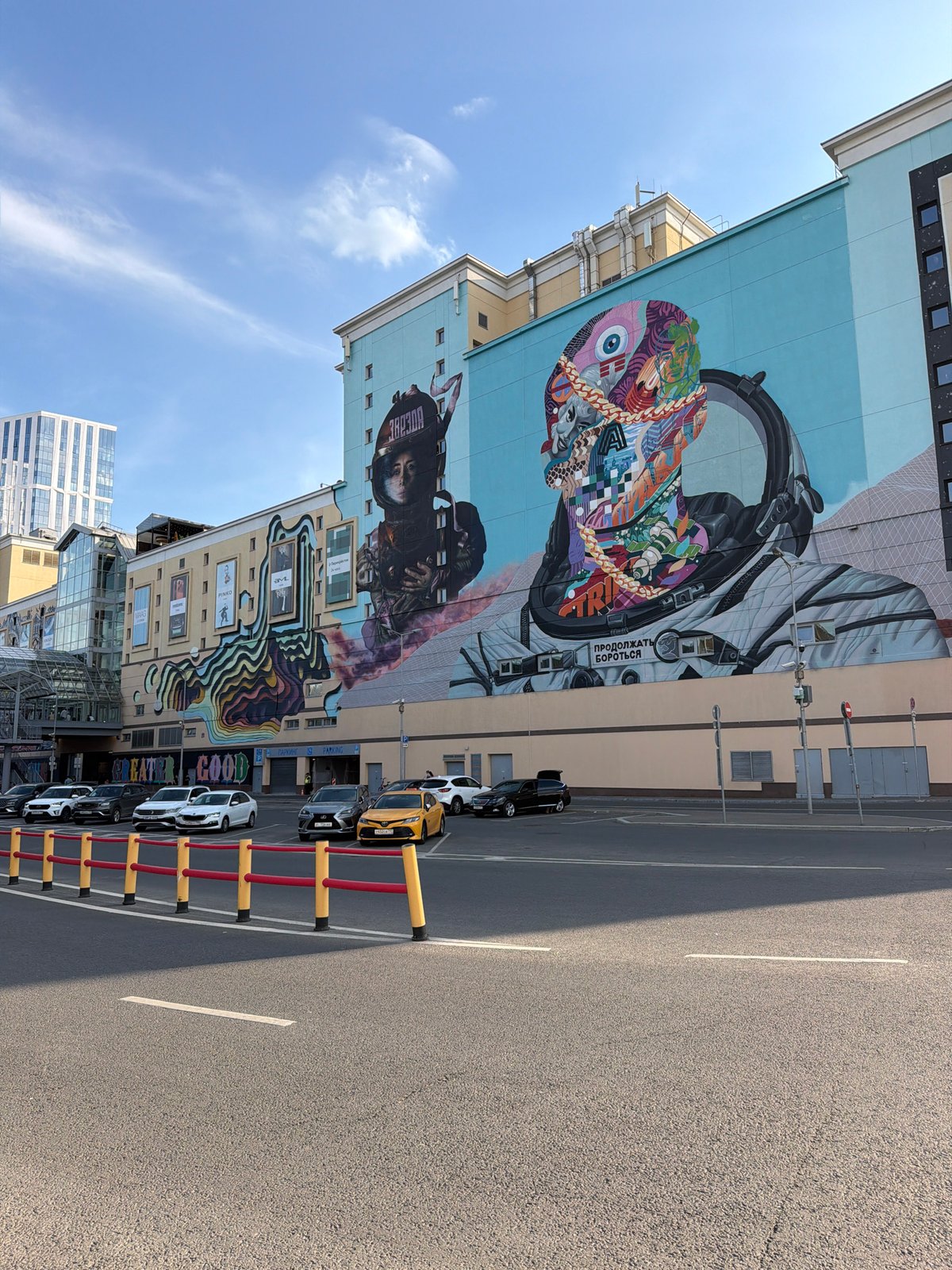 Street murals, metro escalators, and city movement on a July afternoon