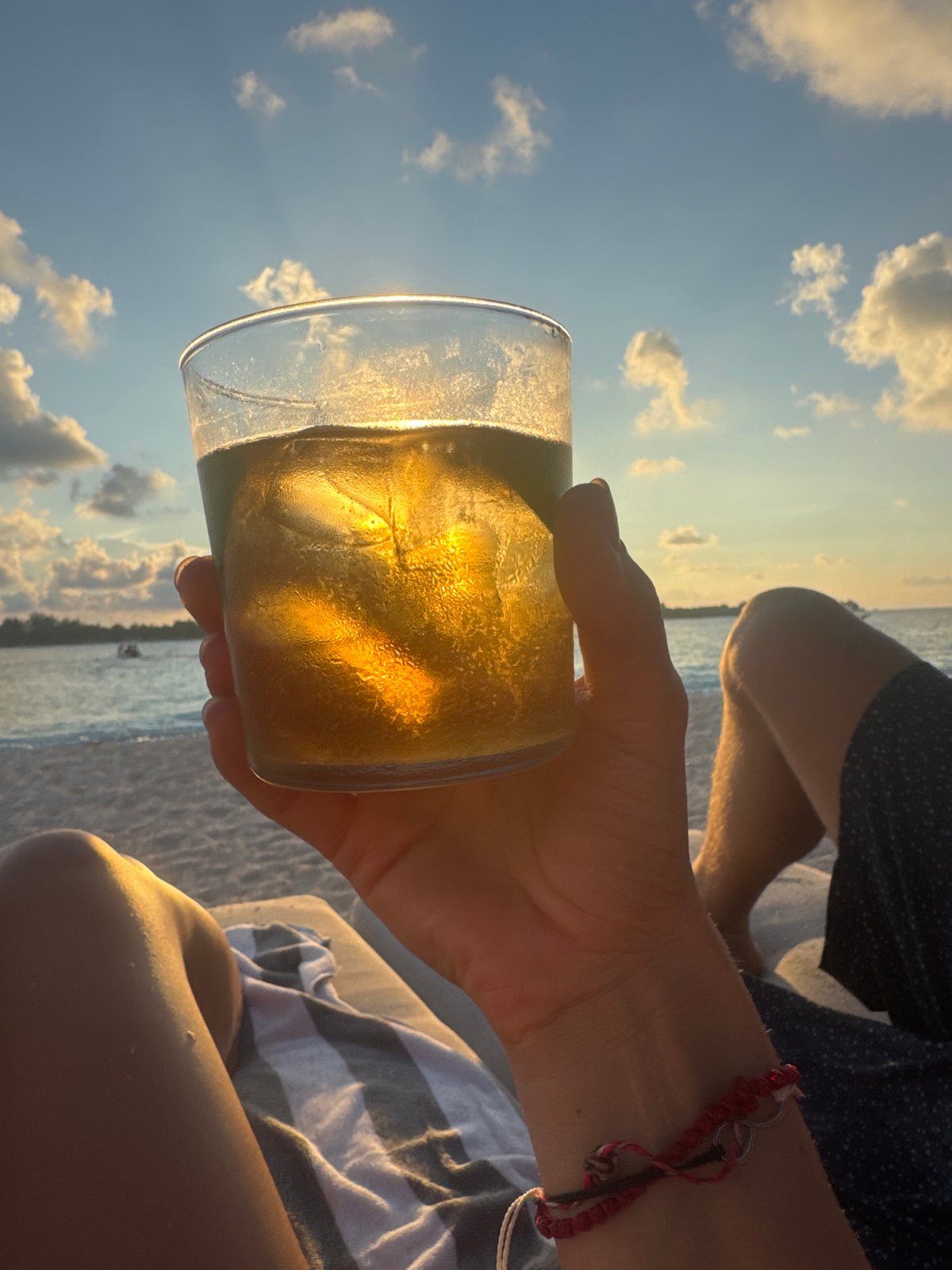 Sunset drinks and serene skies captured at Indonesian beach