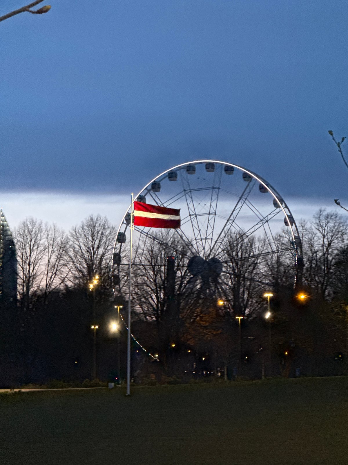 Evening twilight scenes captured in Riga featuring Ferris wheel