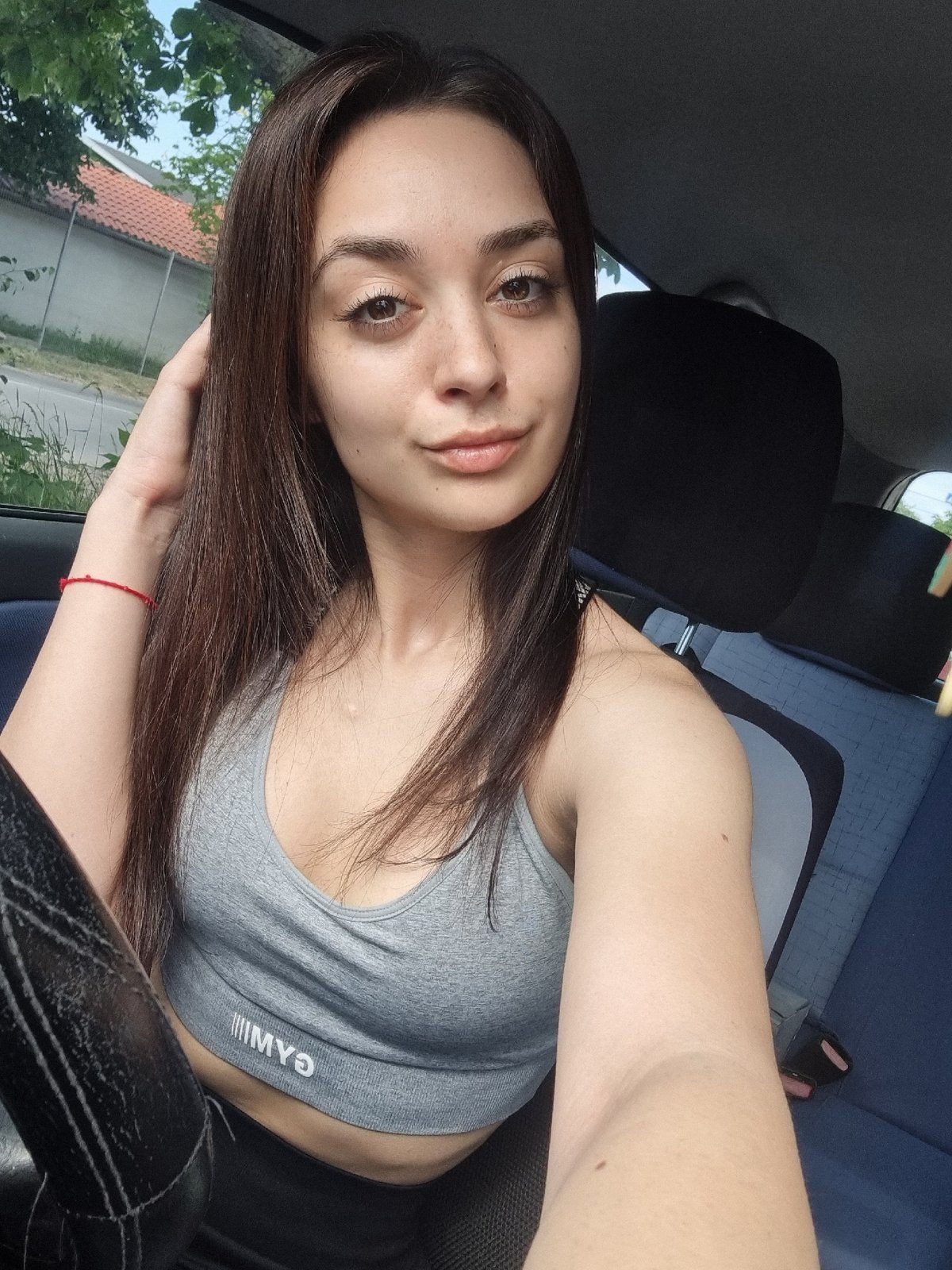 Woman takes morning selfies in car in Sofia