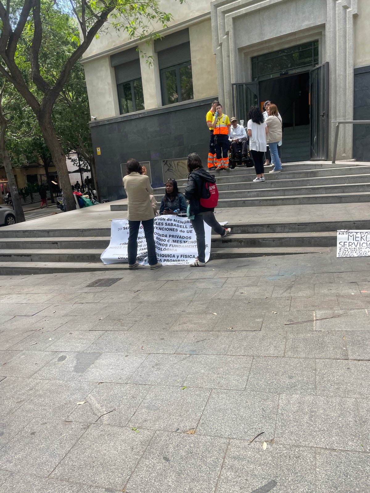 Gathering with protest sign observed on Barcelona building steps