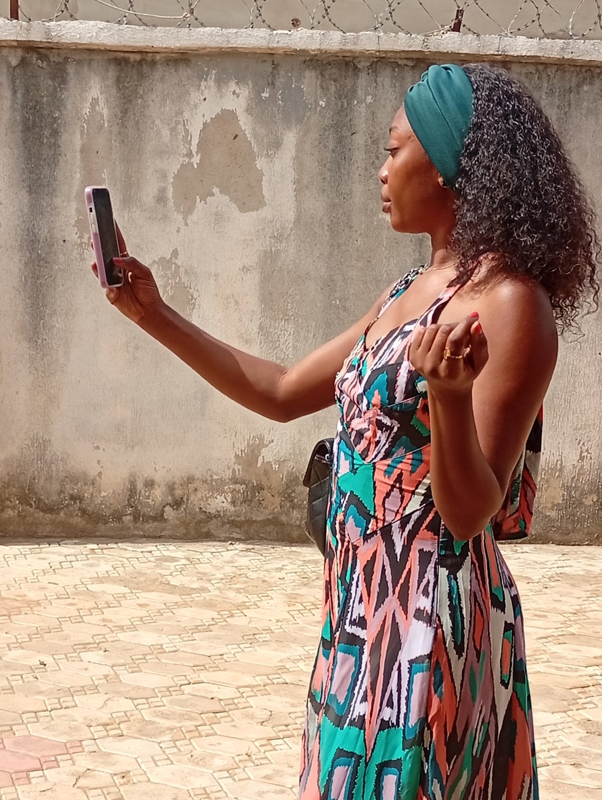 Woman takes smartphone selfies in Rido, Nigeria