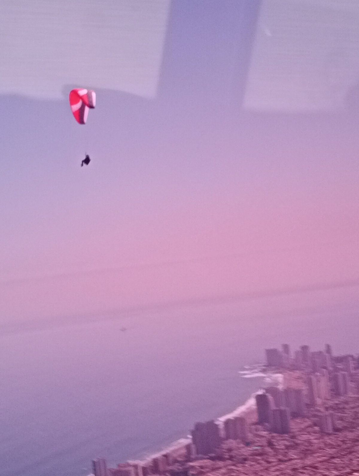 Paraglider soars above Iquique coastline in Chile