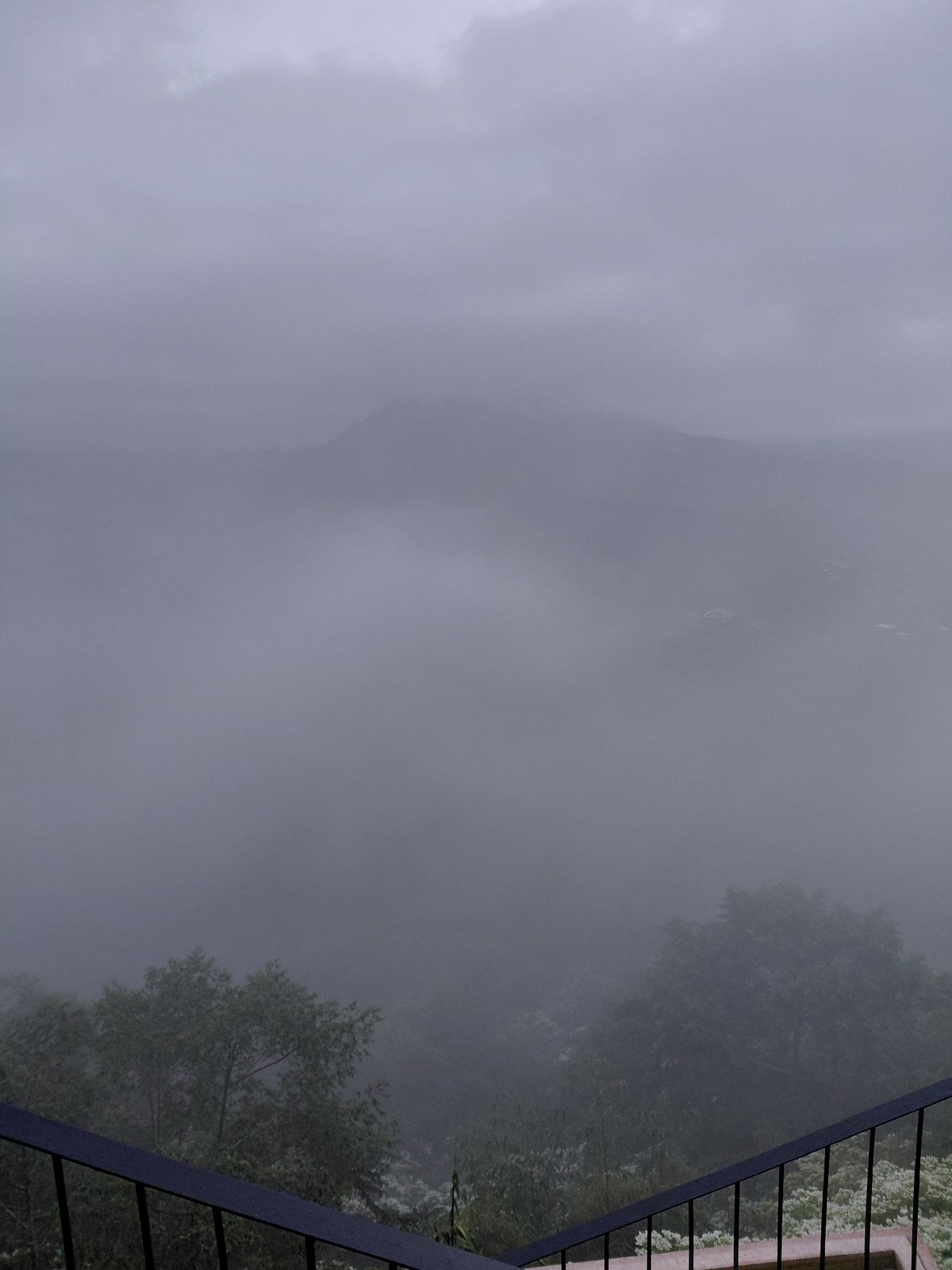 Foggy hillside café stop with rustic interiors and a drone overhead