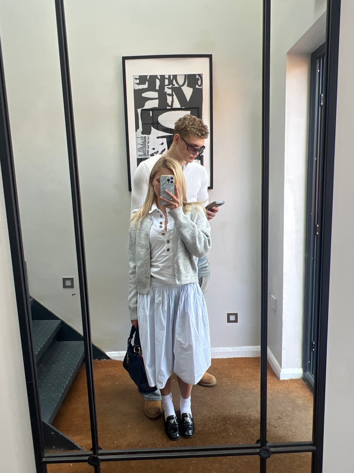 Couple captured in mirror reflection in London