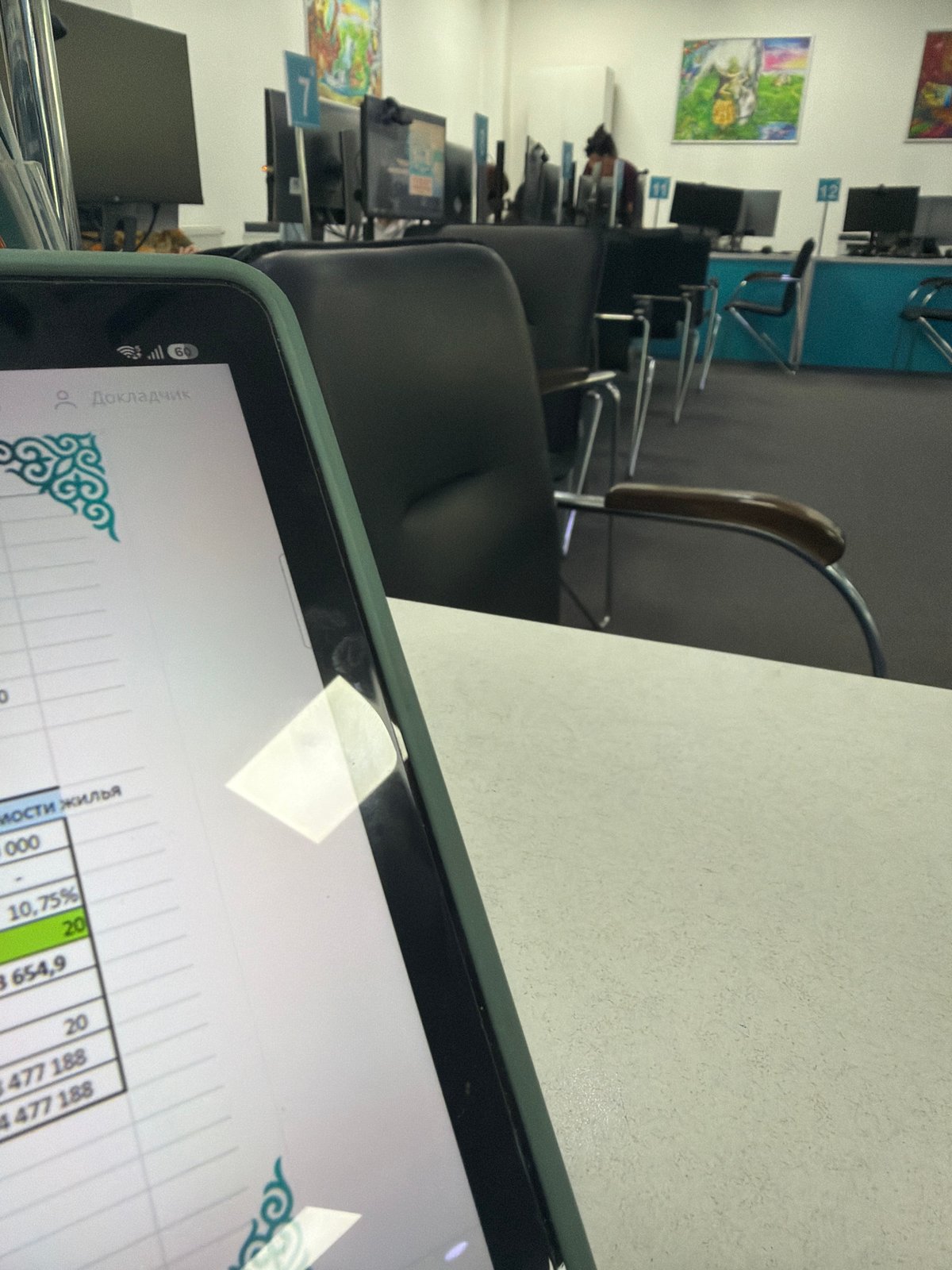 Inside an Astana office: workstations, brochures, and a calculator