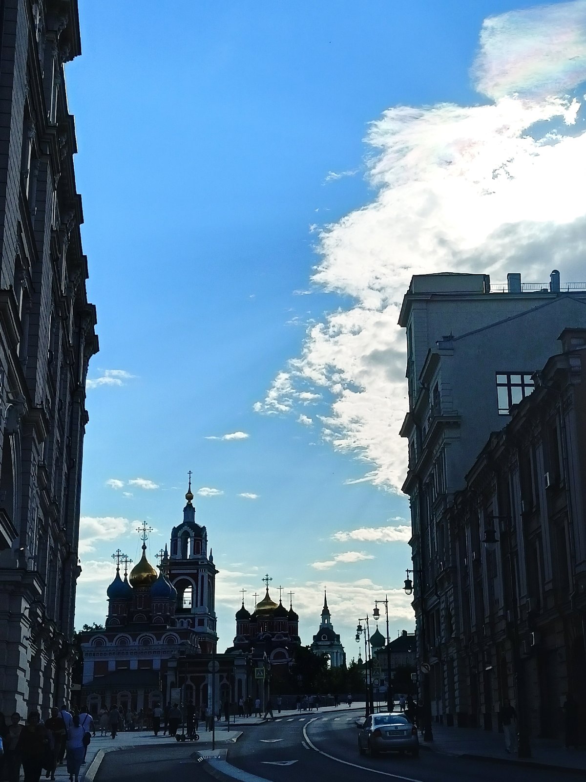 Ornate city streets, a domed church, and sunny skies