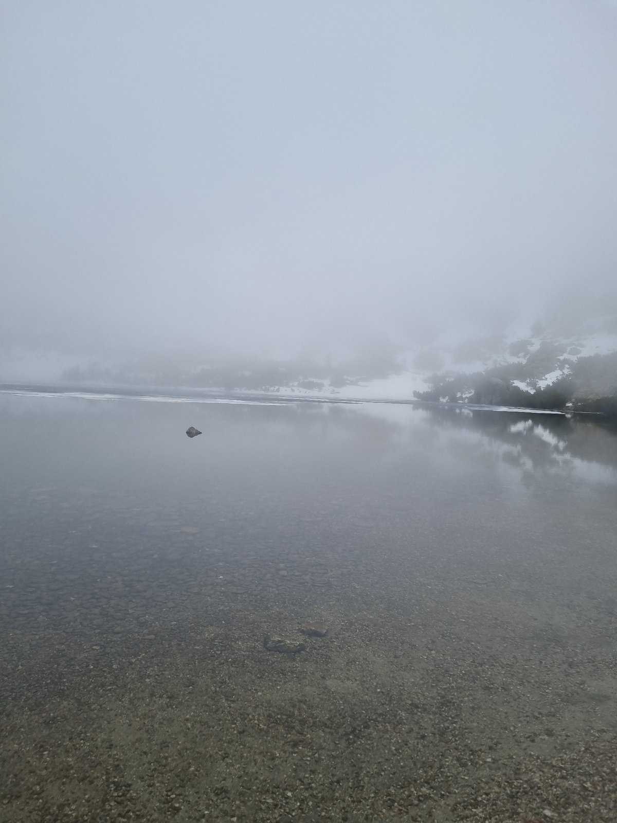 Hiker documents foggy winter conditions at Bulgarian mountain lake
