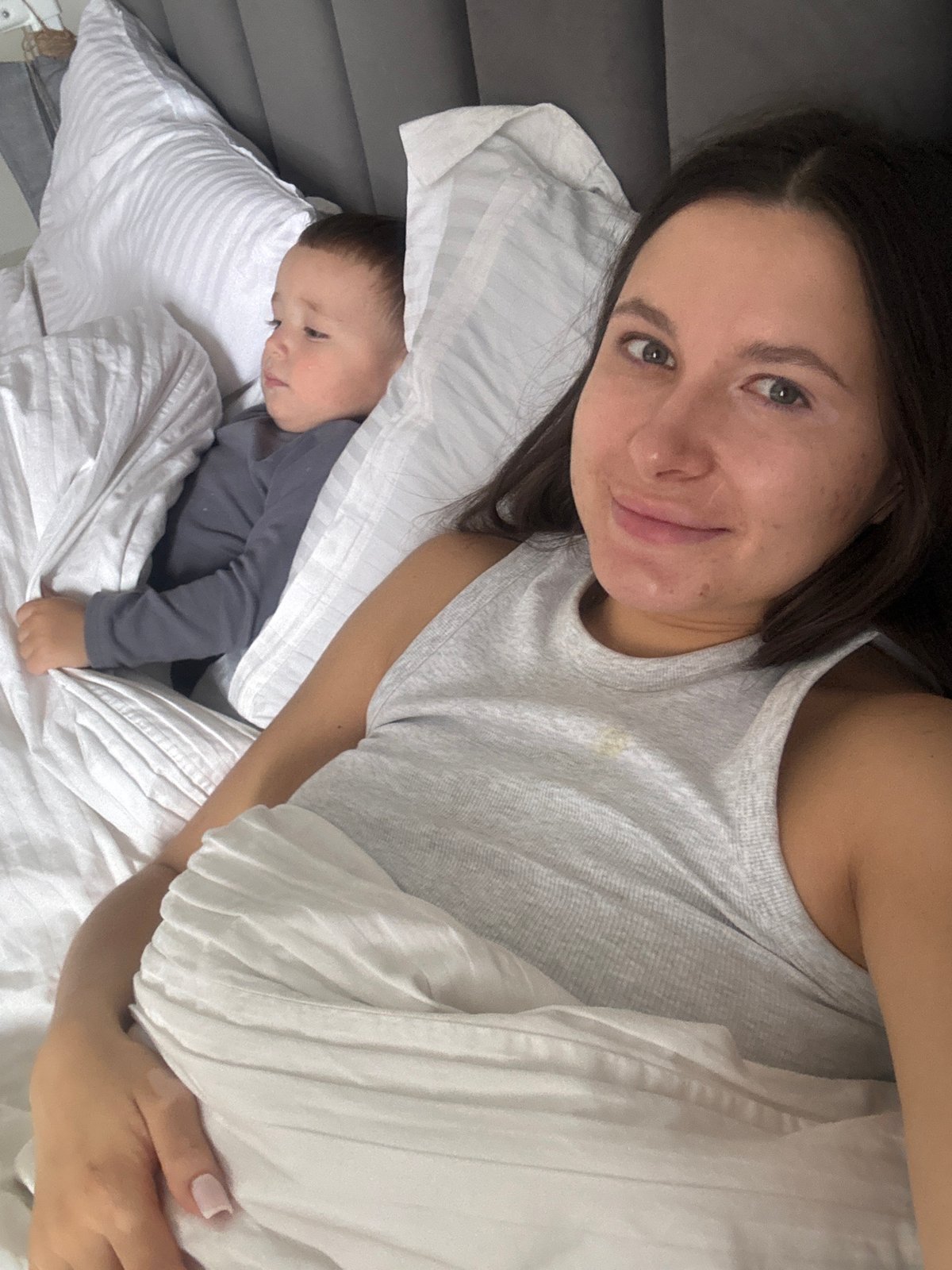 Mother and child share morning moment in Odintsovo bedroom