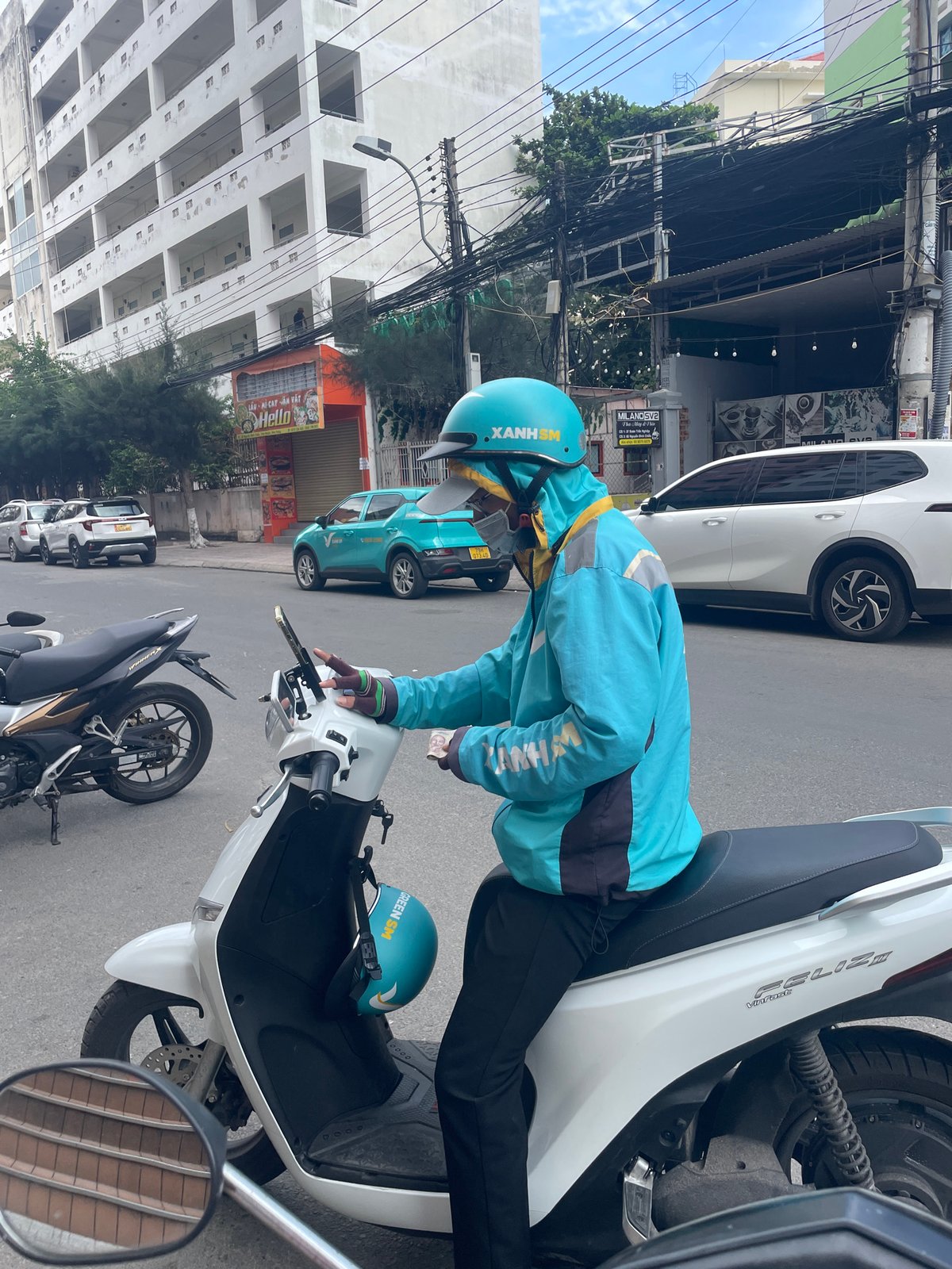 Street life on a Nha Trang morning: scooters, EVs, and locals