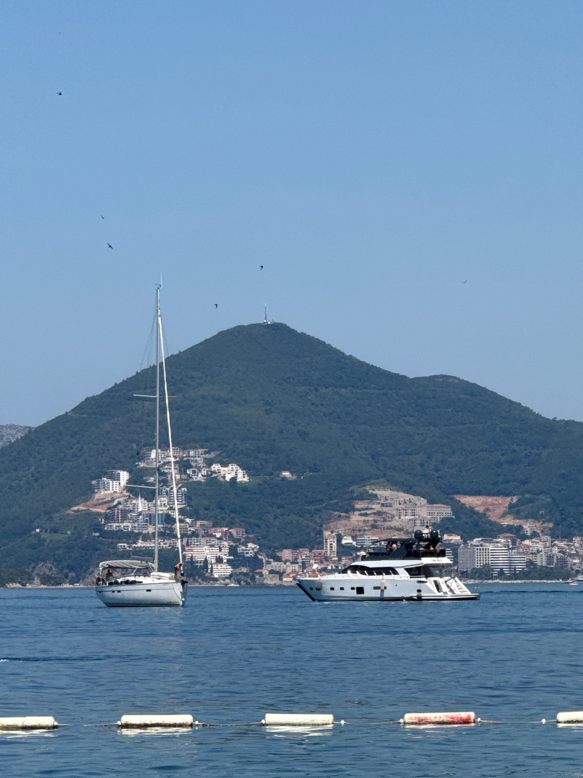 Boat traffic and coastal scenes off Budva on a clear morning