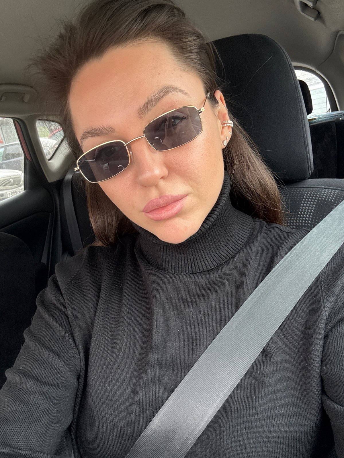 Woman in black turtleneck observed in car, Krasnoyarsk