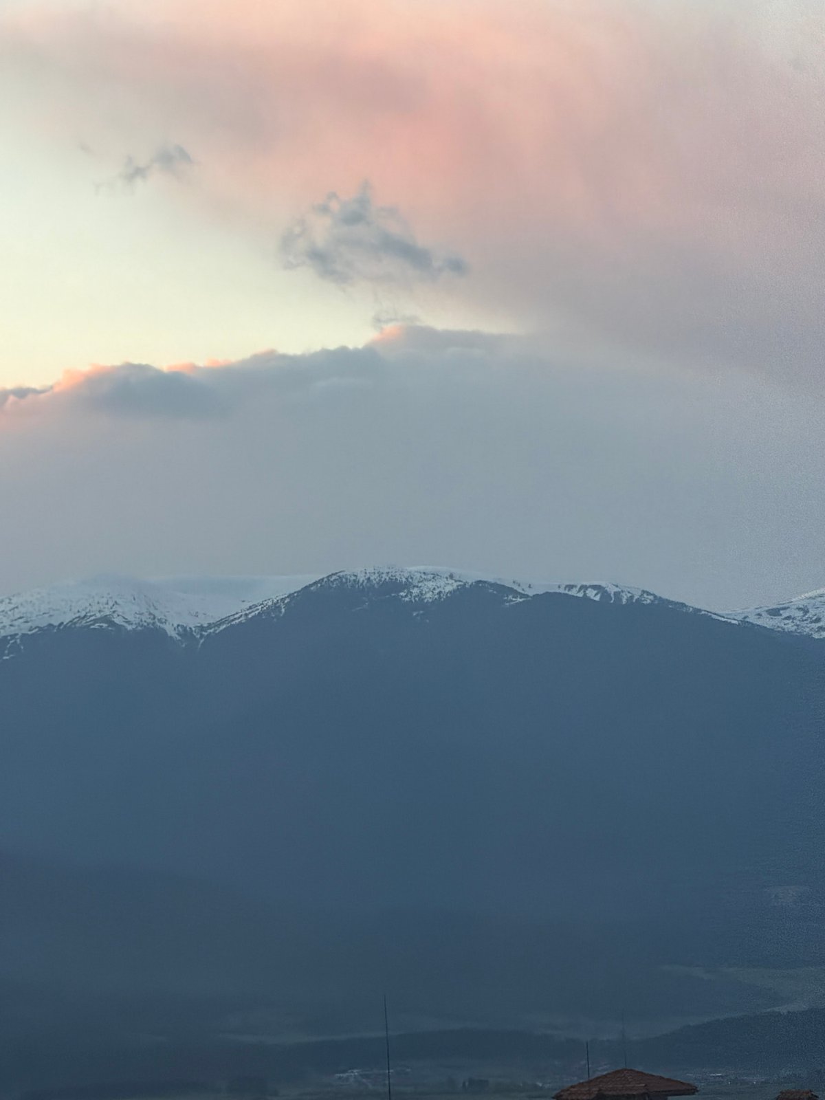 Twilight sky captured over snow-capped mountains in Bansko, Bulgaria