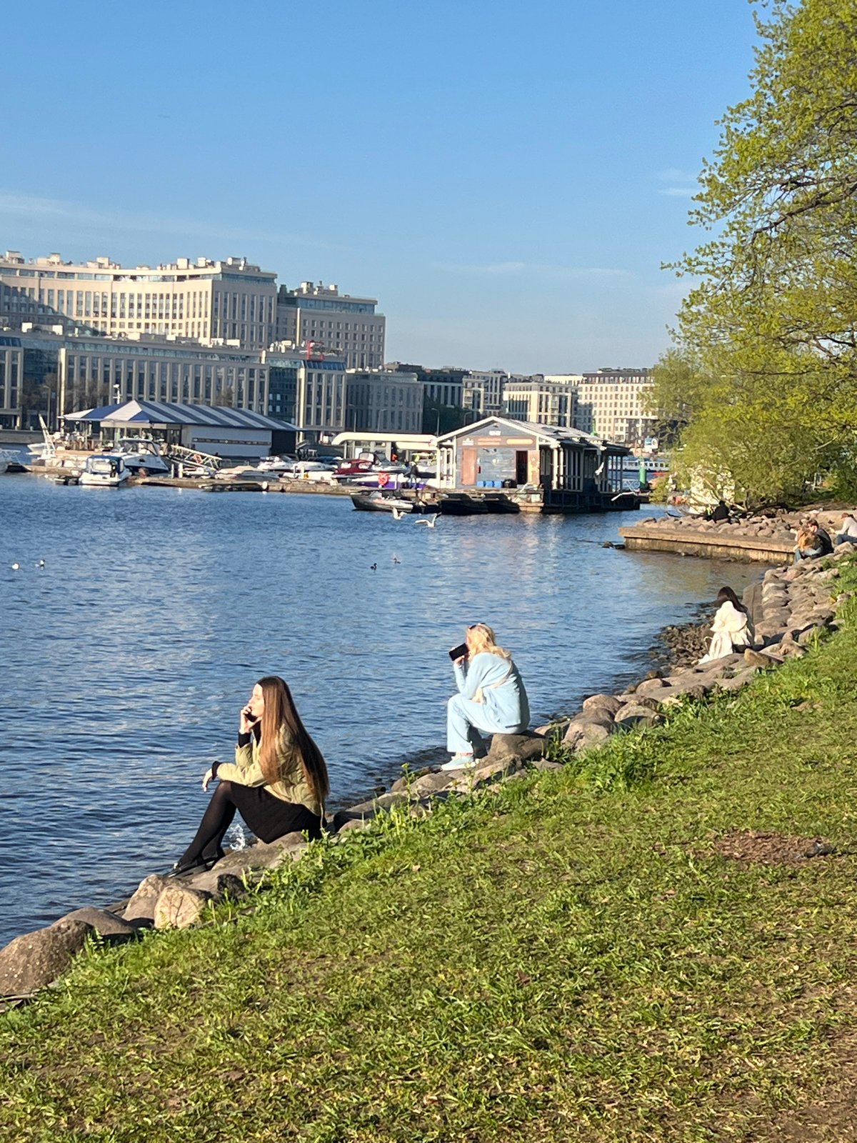 Two people gather at Saint Petersburg waterfront embankment