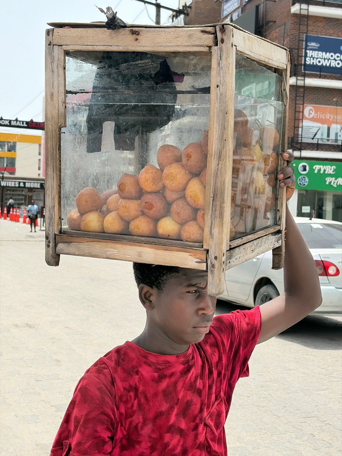 Street vendors active in Alaguntan, Nigeria morning scene