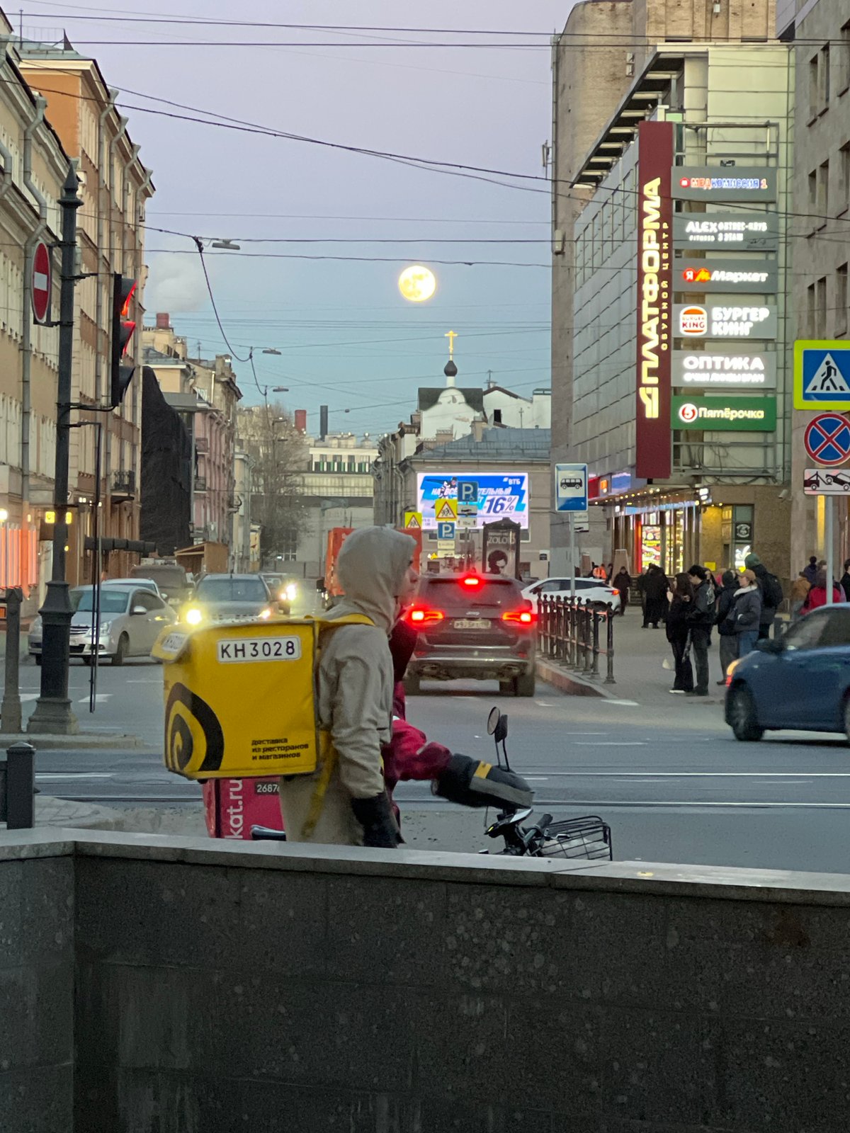 Evening street scenes captured across Saint Petersburg during dusk