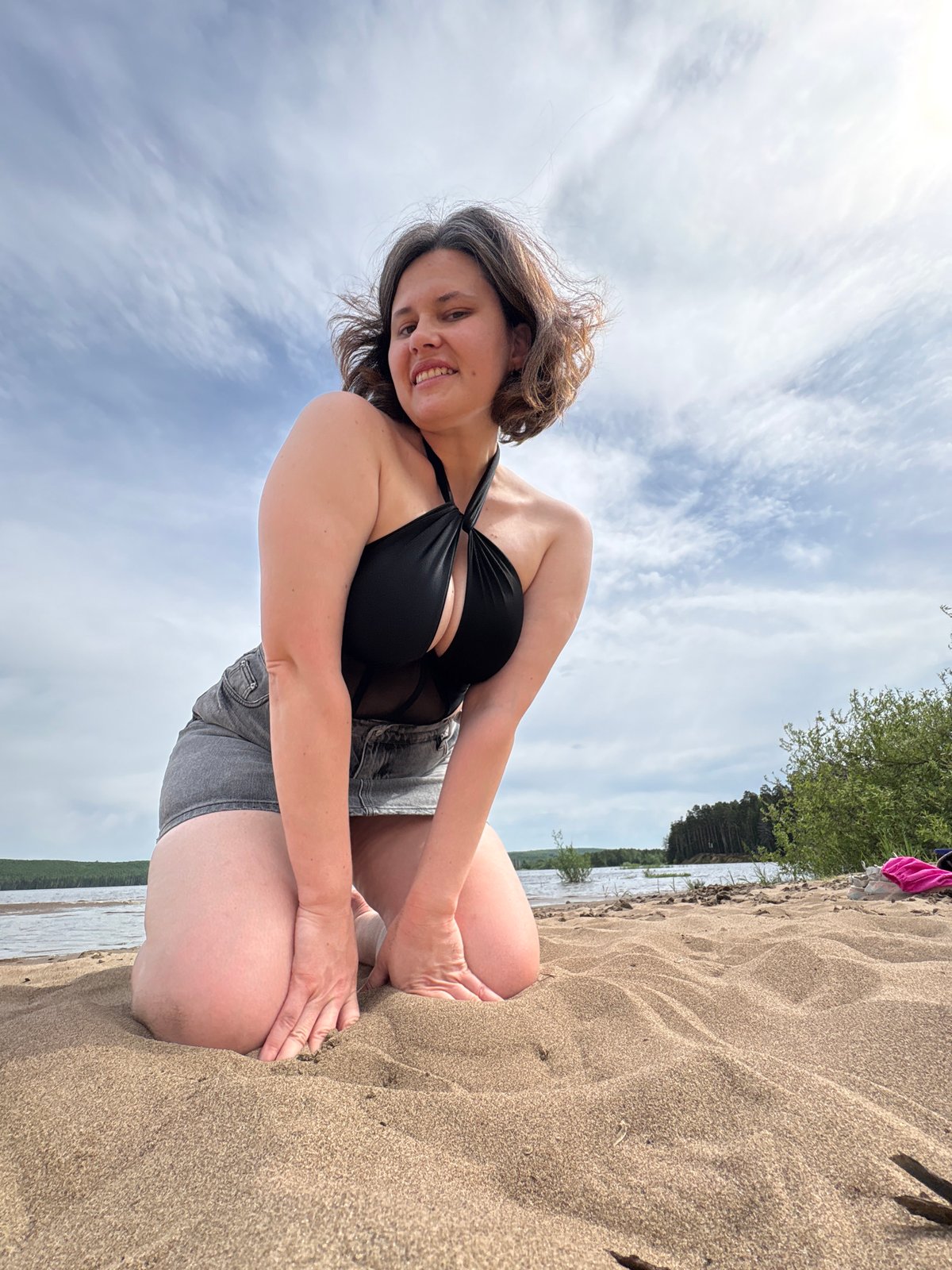 Woman photographed on beach in Chaikovsky, Russia morning scene