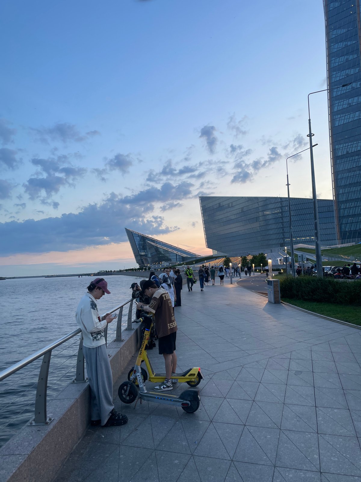 Evening gatherings documented along urban waterfront promenade during golden hour