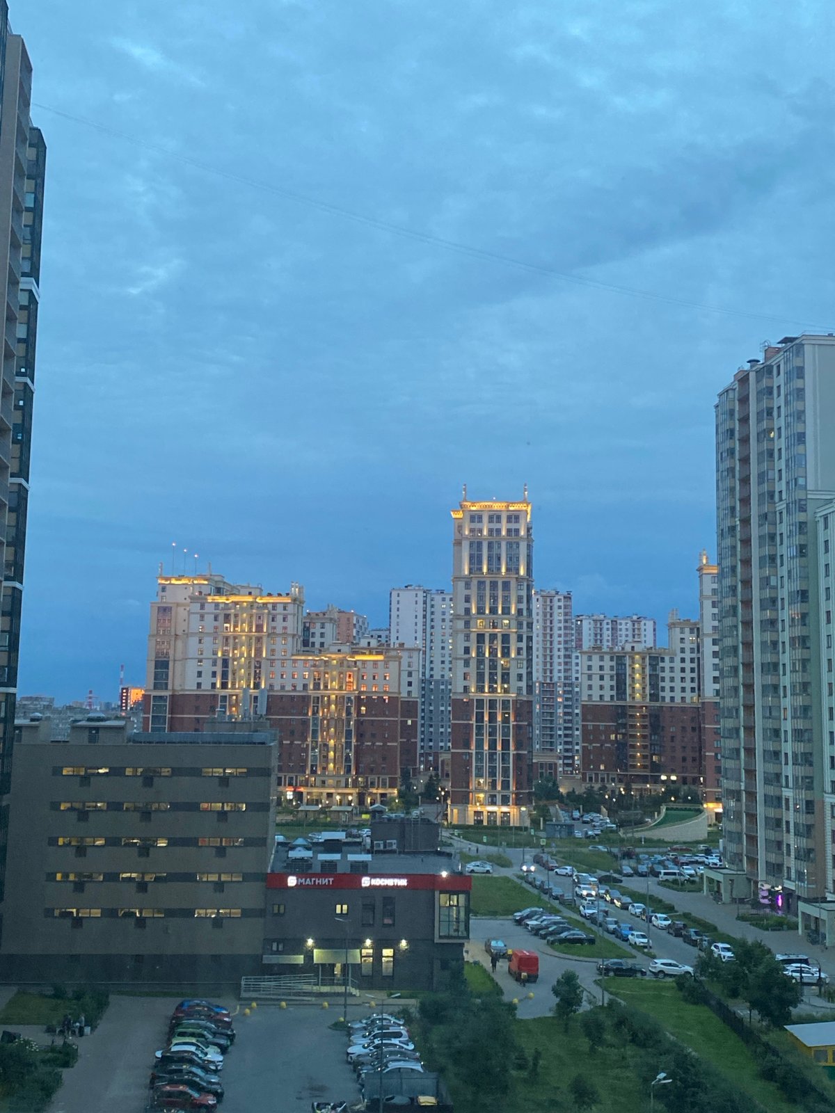 Residential skyline at dusk, high-rises under a deep blue sky