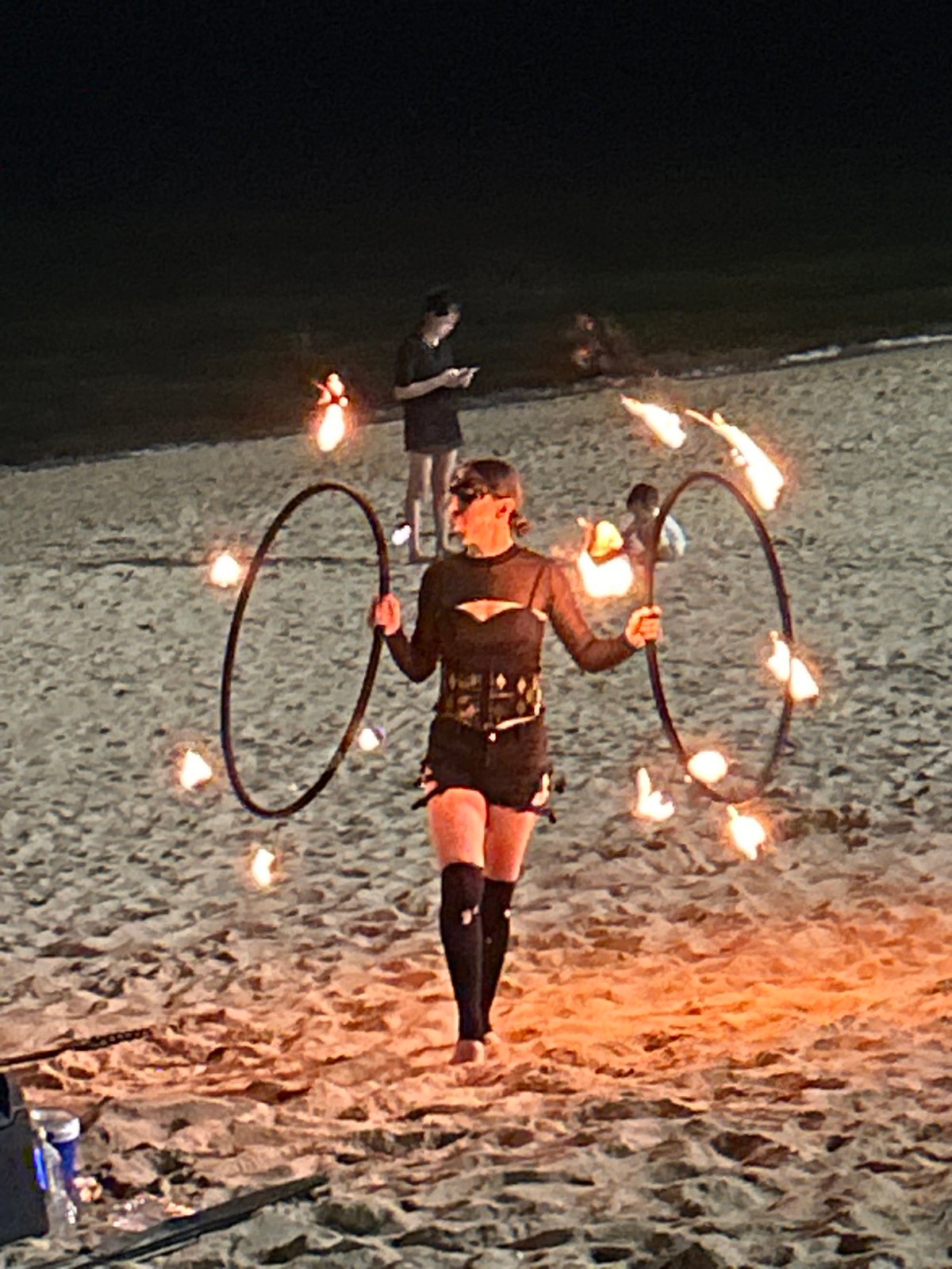 Fire dancer performs on Nha Trang beach amid bustling nightlife
