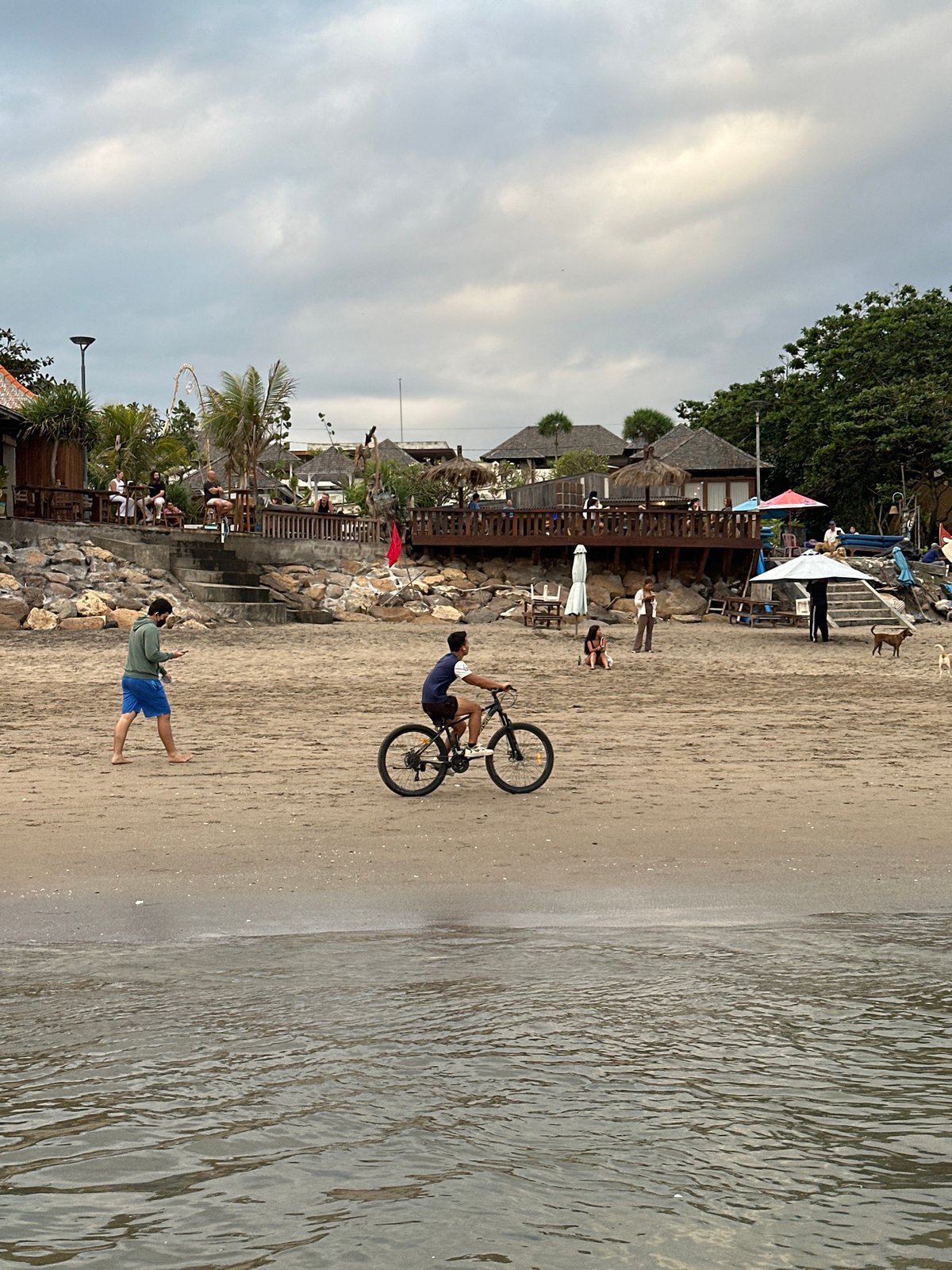 Sunset hour on North Kuta beach, families and dogs in tow