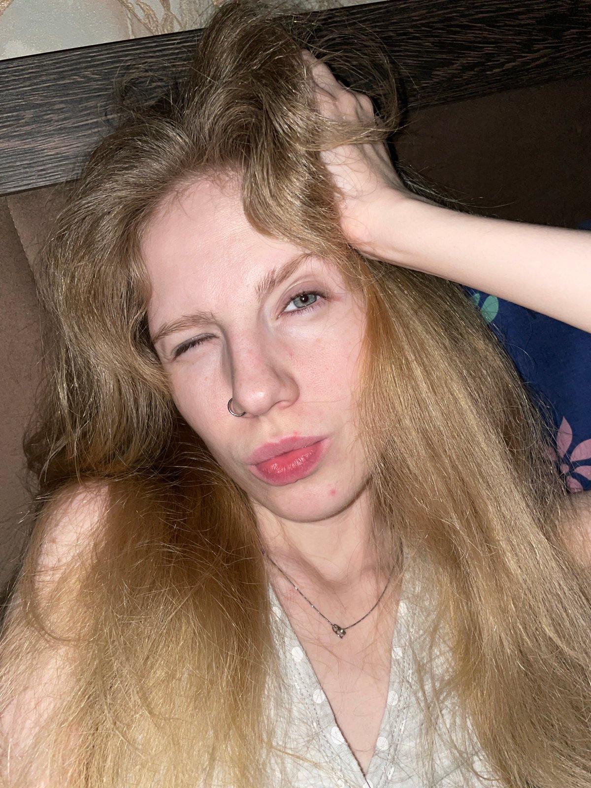 Woman photographed winking indoors in Izhevsk residential setting