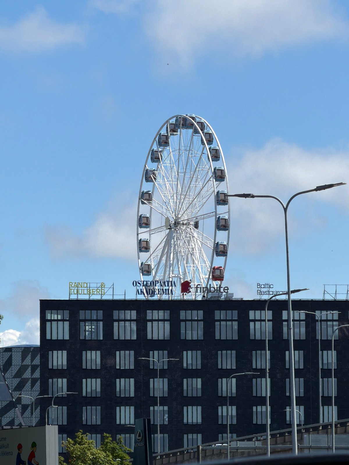 Ferris wheel and industrial chimney share Tallinn's mixed skyline